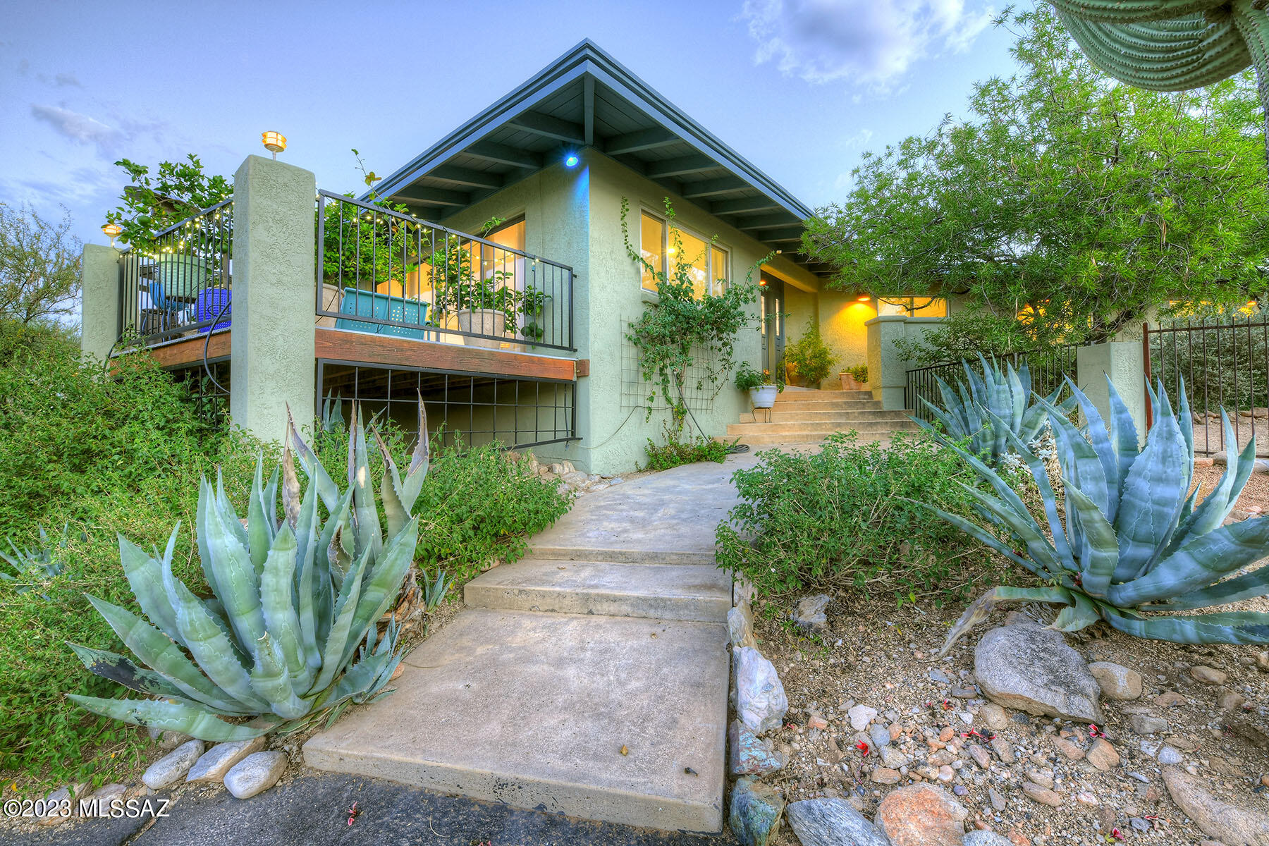 This Skyline Foothills Estates home is a stunning property that has been beautifully renovated with meticulous attention to design and energy efficiency. The highlight of the home is the new modern cook's kitchen, which features quartz countertops, flat panel Alder cabinetry with spacious and convenient storage, stainless steel appliances, and a stylish glass tile backsplash. The kitchen seamlessly flows into a spacious dining area, creating a perfect space for entertaining.
The large living room is a light-filled retreat, boasting a stacked stone fireplace and a wall of glass doors that open to a generous deck. From the deck, you can enjoy breathtaking views of the city lights and mountains. A fruit and flower garden is located off the deck. The entire house features new flooring, dual pane windows, fresh paint inside & out, and recessed lighting, giving it a fresh and modern feel. 
The primary bedroom is a luxurious sanctuary, with a fireplace, newer double-pane windows and patio door, with a separate den/office area and a beautiful ensuite bathroom. The patio door leads to the backyard pool. Additionally, there is a spacious walk-in closet. The 2nd & 3rd  bedrooms are ample and have large closets.
The bathrooms have also undergone stunning renovations. The hall bathroom includes a single vanity, custom lighting, and a shower and tub combo with custom tile. The ensuite bathroom for the primary bedroom features a large glass shower enclosure, custom tile wainscoting, a soaking tub, a double vanity with marble countertops, and custom lighting. 
The energy efficient dual-pane windows combined with owned solar panels provide a near-zero electric bill even in the hottest months. Also included is a water softener and a reverse-osmosis water filtration system. For added convenience, there is a separate heated and cooled 11' x 9' storage room, brand new septic and a large 2-car garage.
In addition to the south-facing front deck, the property offers a deep covered patio on the northwest side, with a vintage outdoor kitchen, perfect for al fresco dining and entertaining. There is also a fountain and a large pebble tech (installed in 2021) pool,  surrounded by mature landscaping, creating a serene and private oasis. 
This home is situated on a generous one-acre lot nestled in the Catalina Foothills, in a highly desirable location known for its natural beauty and breathtaking views, with easy access to downtown and the University.