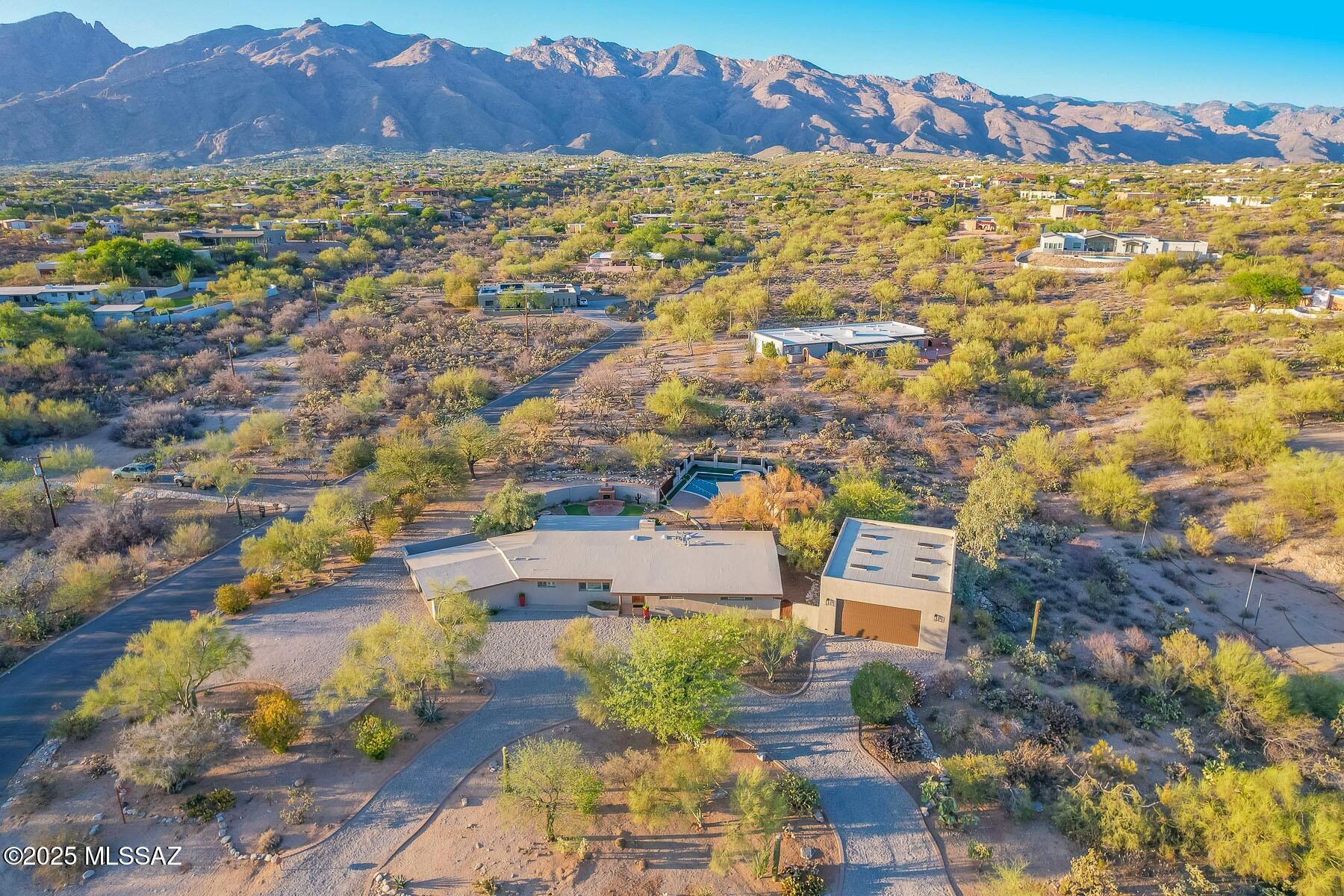 Welcome to your private Desert Sanctuary! Situated on a spacious 1.07 Acre Lot in Flecha Caida Ranch Estates, this exceptional property perfect for Auto Enthusiasts, Hobbyists, Entertainers & all Fun Loving Folks! Multiple Garages, including the Exceptional 1080 Sq Ft 6-Car, Detached Garage w/ 12' Ceilings & Built-In Cabinets. Step out back & immerse yourself in Resort-Style living w/ sparkling salt-water pool and spa, built-in BBQ, lattice covered dining & gorgeous fireplace patio.  Mature landscaping and uninterrupted Mountain Views! Charming Flecha Caida ranch-style masonry home built in 1959 & dramatically improved over the years, including newer stucco exterior. Comfortable, flowing floorplan features cozy Living room w/ custom Canterra Fireplace. Award Winning District 16 Schools