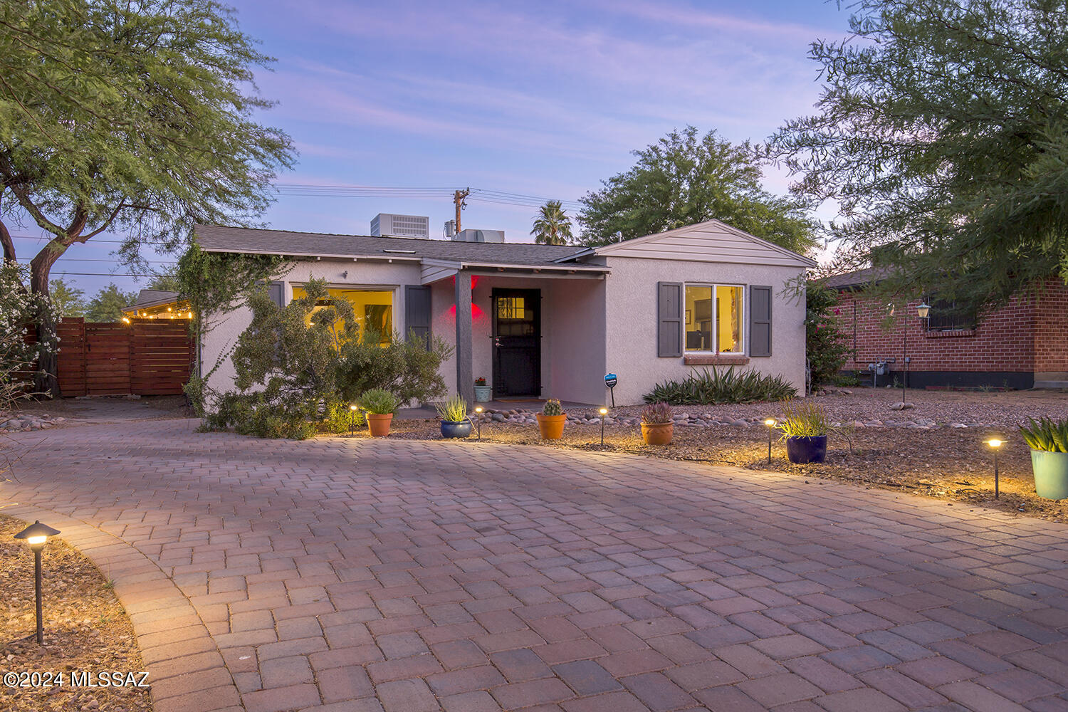 A Poet's Square/Corner gem. This thoughtfully updated 1948 abode has all the charm, functionality and comfortable spaces in a quaint and established central / midtown Tucson neighborhood. Close to many restaurants, coffee shops, parks, retail shops & venues, and this home is within walking distance to quite a few. 
This home sits on an elevated corner lot with a north facing picturesque mountain view, and a circular driveway. The classic design touches in this home are timeless and beautiful throughout. Enjoy the split floor plan that provides a generous primary bedroom, bathroom and large walk-in closet, and three additional spacious bedrooms and a full bathroom. Along with a chef's kitchen at the heart of the home. The beauty of this home extends to all the outdoor spaces. There is a fully bricked, covered back patio, landscaped and manicured front and backyard with fruit trees (lemon, lime & fig), all on a rainbird irrigation system. The perfect  little oasis in the desert.  

Quite a few substantial upgrades have been made to the house over the last year, such as the new 5 ton / 19 SEER  HVAC unit, duct aerosealing throughout, temperature control service plan, installation of sewage cleanouts and an 800 gallon rainwater tank installed.