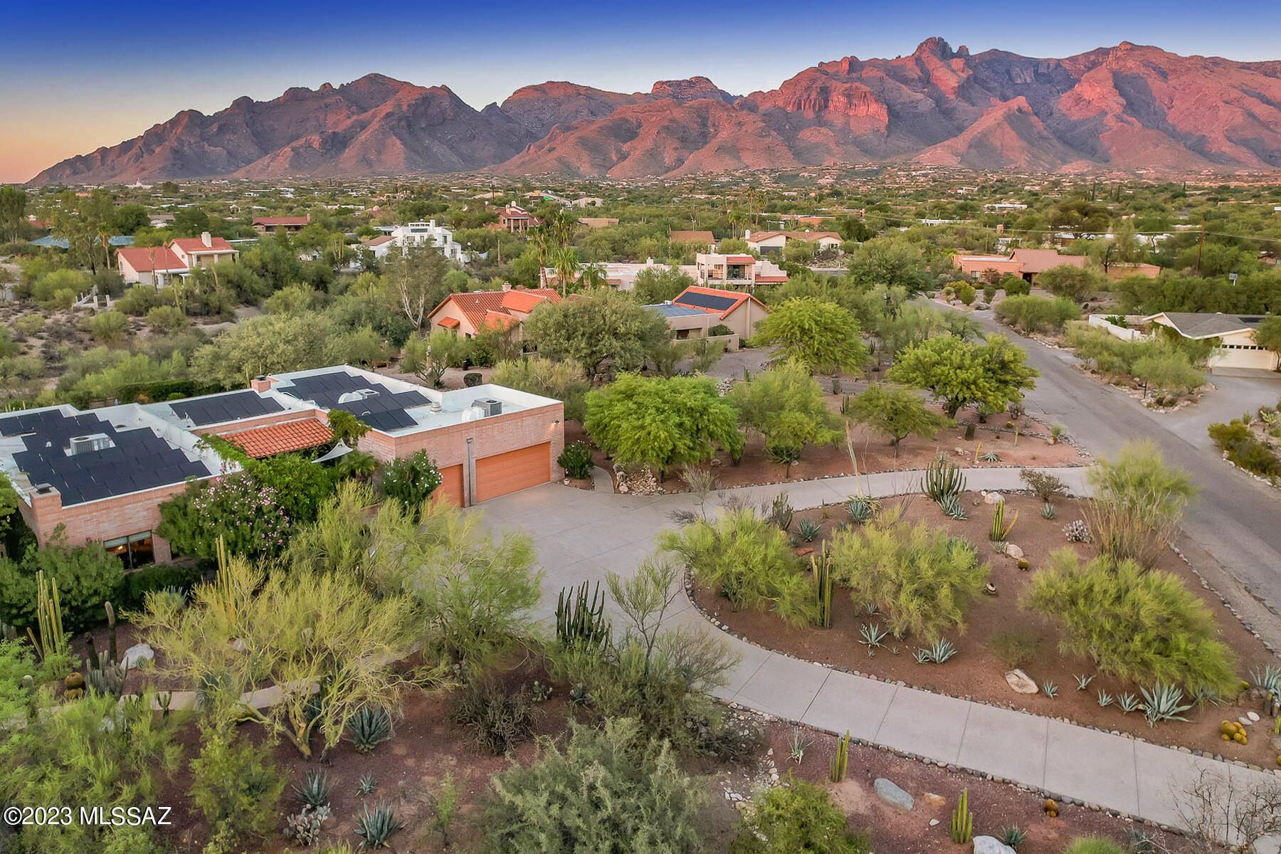 Tucked away in the tranquil Shadow Hills neighborhood, this gem of a property spans close to 1 acre, seamlessly blending art, comfort, and nature. Owned by the distinguished Tucson artist, Barbara Rogers, this 3,224 sq. ft. abode carries her signature touch, offering a sanctuary for those who appreciate beauty in every corner.

With a well-thought-out split bedroom floor plan, the residence presents four spacious bedrooms and three elegantly designed baths. Large windows invite an abundance of natural light, creating a warm and inviting ambiance throughout. Dual fireplaces, located in the living and family rooms, further enhance the home's cozy atmosphere.

While the kitchen is adorned with sleek granite countertops, it's the dining room that truly captivates, as it gracefully opens to the property's pièce de résistance: the iconic cactus garden designed by Plants of Distinction. This meticulously curated space boasts a diverse range of desert plants and cacti, punctuated by a serene Buddha statue that conveys with the home.

Located on a peaceful cul-de-sac and adjacent to a wash, the property effortlessly blends with the native species, creating a retreat for local wildlife. This harmonious connection with nature is further highlighted by the mountain-view pool area, offering a refreshing oasis amidst the desert.

Additional features include a three-car garage, equipped with both heating and cooling, and a myriad of spaces ideal for both relaxation and entertainment. Whether you're taking in the beauty of the cactus garden, enjoying the warmth of the fireplaces, or simply appreciating the artistry inherent in every detail, this home is a testament to refined living in the heart of the foothills.