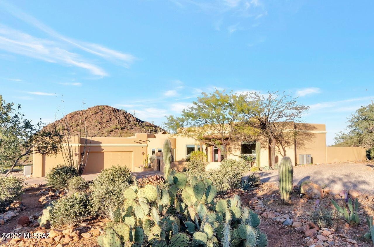 Private Custom Home situated on 3.4 acres. 4 Bedroom 3 Bath, 3 car garage in the beautiful Tucson Mountain corridor. Only minutes away from downtown Tucson, where all the great restaurants, breweries, shopping, and the arts are found. Enter through the front courtyard to see walls of windows overlooking the Resort like backyard with Pool, spa, firepit with Banco seating area, outdoor BBQ/kitchen, covered wrap around patio, Spectacular mountain views, amazing city views, Front of home facing Saguaro National Park, and breathtaking sunset views. Kitchen offers granite counter tops, stainless steel appliances, center island, Opens up to family room. Separate Dinning and living room with fireplace. There are 3 fireplaces in the house, concrete flooring, two gate codes for the added privacy.