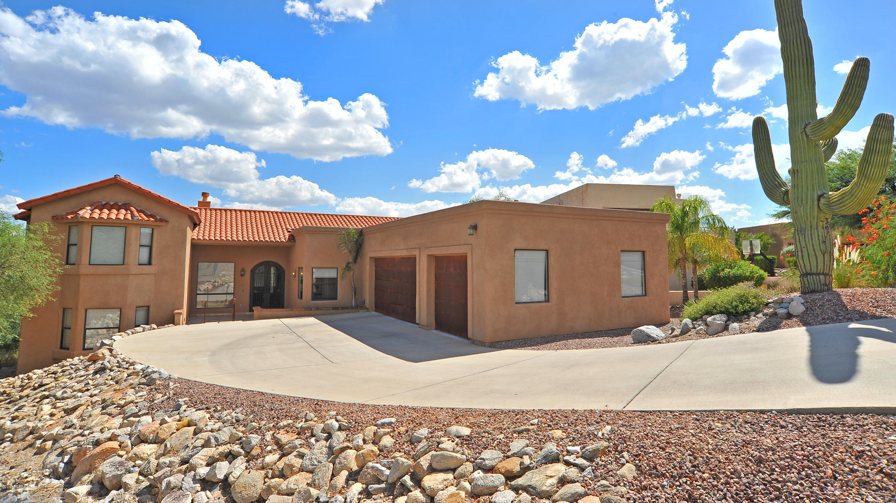 Incredible views out of every window! located in the prestigious Regal Manor subdivision near  Ventana Canyon, Sabino Canyon and many upscale resorts, shopping and restaurants
Long concrete driveway for extra parking, large 3 car garage with copper doors and plenty of storage.
Extravagant double wrought iron entry doors leading into the formal living/dining room.  Cantara fireplace, vaulted ceilings,  fans, two tone paint and Travatine floors
French door leads out to oversized covered patio.  Enclosed yard with block wall, artificial grass and incredible views in all directions.
The gourmet kitchen boasts maple cabinets with 42” uppers, large island with 5 burner gas cooktop, built in microwave and oven, desk area.