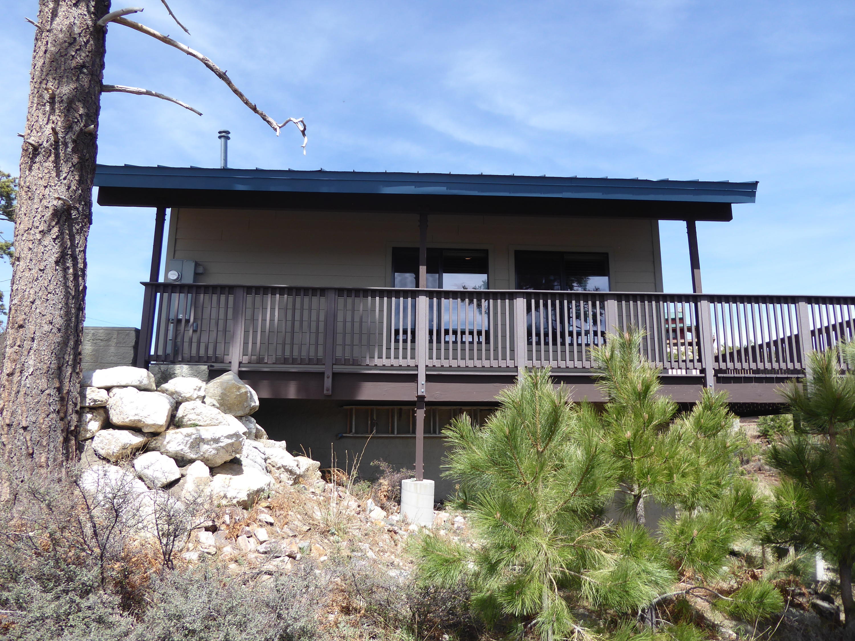 Nice cabin with year around access in a quiet area on a very large lot. Large wrap around trex deck with low maintenance. Beautiful views. Main floor is a large open floor plan with lots of windows for natural lighting. Downstairs has a extra bedroom and bath. Utility room with a door to the out side. Circular drive for your guest with year around access. Full grown ponderosas give the cabin shade. Tile throughout the cabin for easy maintenance.