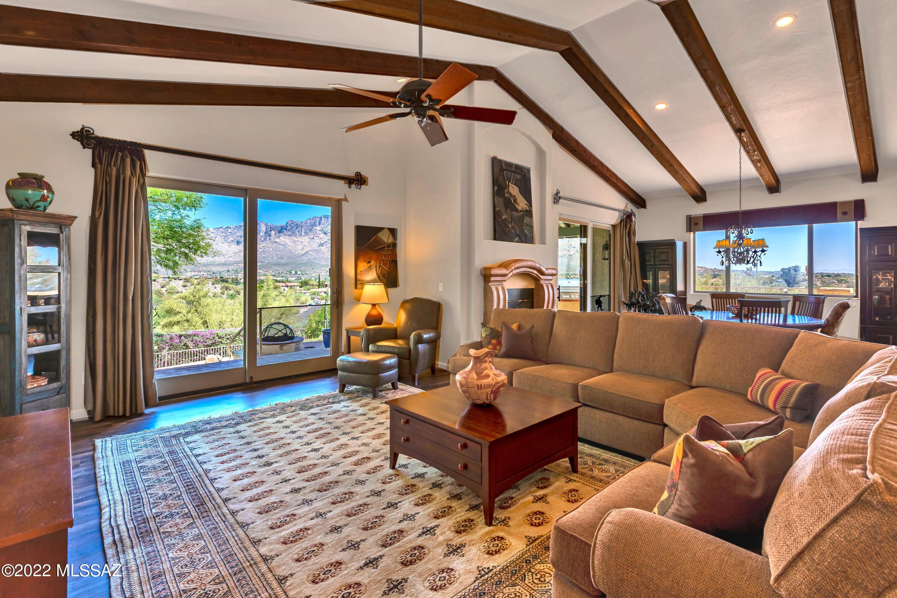 Gorgeous panoramic views of the Catalina Mountains! Home sited on an elevated 1.16 acre corner lot creating your very own private oasis. As you enter the home you are greeted with breathtaking mountain views from every direction. Kitchen features views of the city, dual ovens, gas cooktop, tile backsplash, granite counters, Hickory cabinets, roll-out shelving, under cabinet lighting and stainless steel appliances. Spacious primary suite with en-suite includes large walk in closet with custom shelving, garden tub, tiled shower and dual vanities. Extended 2.5 car tandem garage has attached hobby room. Backyard great for entertaining with built-in BBQ, gas fire pit, heated pool/spa and satellite patios.