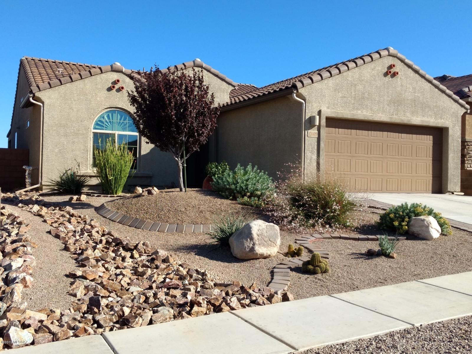 Light, bright and immaculate! 2 Bedroom/3-car Tandem Garage in Del Webb at Rancho del Lago, a gated, active adult (55+) community in scenic Vail. Natural desert rear buffer. View to Rincon Peak from North-facing Ext Cov Patio. Stylish cabinetry, spacious Kitchen, quartz counters, walk-in pantry. Lg circular island is the center of attention, perfect for entertaining. Center sliding doors open from Great Room onto a beautiful pavered patio trimmed in colorful plantings. Comfortable Master Suite. Split layout. Refr, washer/dryer incl.  Util sink, water softener, RO, tankless H/W, rain gutters, security doors, epoxy garage, overhead racks. Amenities include Pools, Spa, Tennis, Pickelball, Jogging path, sidewalks, Lodge, fitness center, and more! Nearby Del Lago Golf, shopping and restaurants.