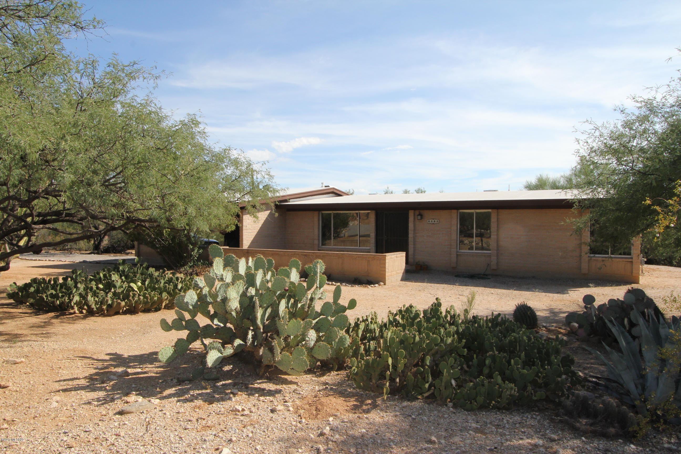 You will fall in love with the views from this beautifully updated family home now ready for the next phase of ownership. Nestled close to the mountains on nearly 3/4 acre w/ desirable N/S exposure. Spacious, open feeling throughout with lots of light! Family/great room w/ fireplace adjoining the kitchen, or step out to the porch for alfresco dining. New Granite counters in the kitchen, Quartz in both baths along with executive height vanities.  All new bath and lighting fixtures.  New paint, wall and ceiling texture & wood look tile throughout.  Carpet in bedrooms & LR. Brand new HVAC, lots of storage inside and out. This home is surrounded by beautiful Sonoran desert for that open ''country home'' feeling yet minutes to city conveniences. Neighborhood sells quickly and this one is a Gem.