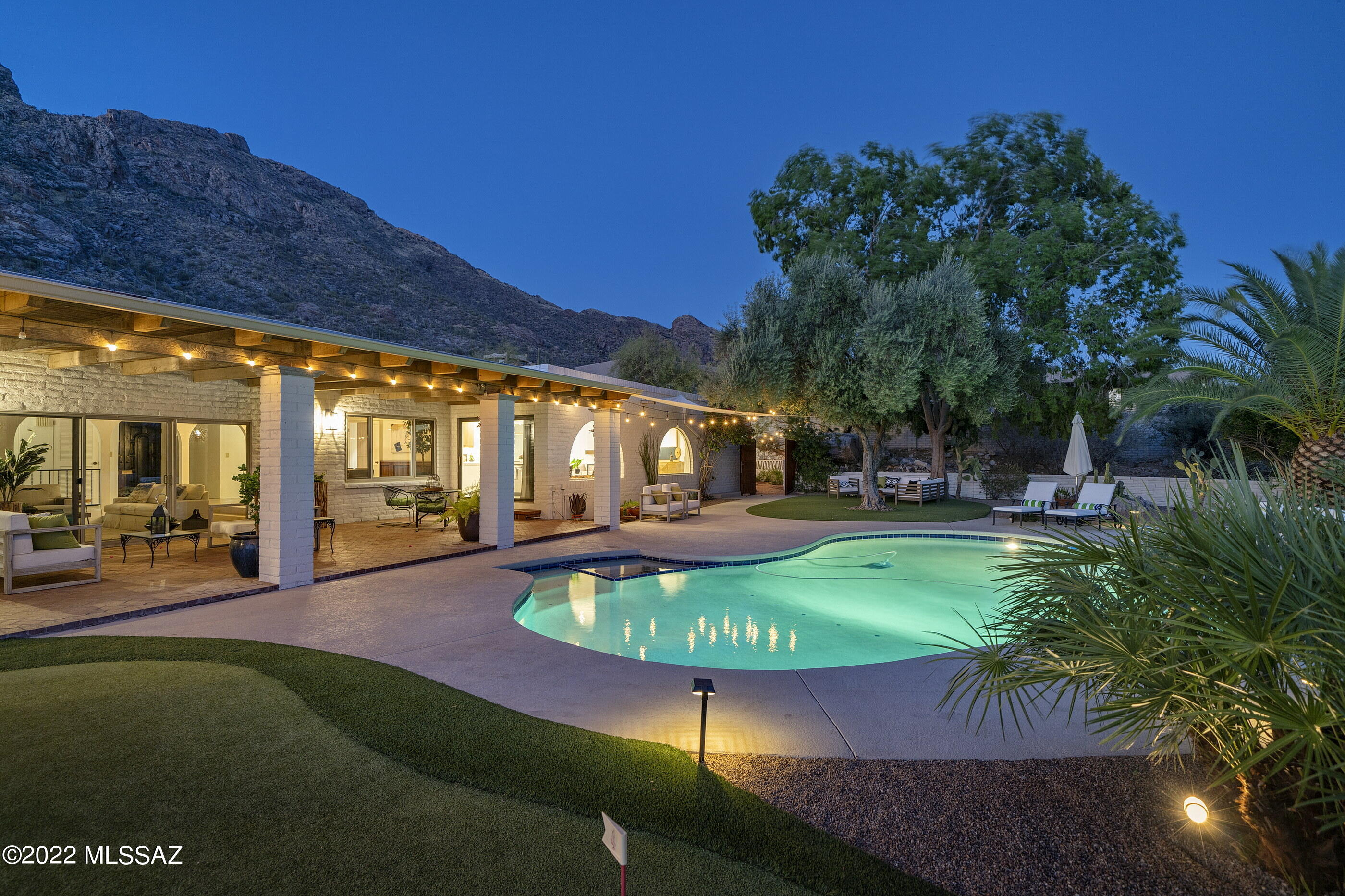 Enjoy some of the most dramatic mountain and expansive city views stretching out over the valley below, from this privately situated residence. This thoughtfully crafted and timeless estate home features classic detailing with a modern ease and intimate luxury, offering a flexible floor plan with 5 bedrooms and 4 bathrooms (which includes an 868 square foot private guest suite). Striking the right balance of form and function creates a sophisticated yet cozy environment, elegantly updated with painstaking detail. An extensive list of recent updates includes: all new kitchen, flooring, appliances, bathrooms, tile, lighting, painting, and more.

Evoking family-style living and employing an open-living dining and kitchen area, acting as the primary gathering point. The heart of the home is the fabulous chef's kitchen with gorgeous finishes throughout, which include custom millwork, with exposed natural wood cabinet uppers, juxtaposed against white lower cabinets, and drawers dressed in honey bronze hardware, set against the soothing white quartz countertops. 

The kitchen flanks the spacious dining and formal living rooms designed to substantial scale and comfort. As one travels between the individual spaces, dramatic landscapes unfold, allowing for an abundance of natural light from every room. Transparent facades, with multiple points of egress, fuse indoor and outdoor living environments, used to derive a sense of spatial richness. The striking owner's suite, sequestered on the Southwest end of the residence, features an expansive, spa-like bath, both voluminous and bright, offering top end fit and finish throughout, as well as a private flex room, perfectly suited for a home office, gym, or artist retreat.

An 868 square foot guest quarters has been sited on the East end of the property, strategically located to extend privacy for guests and owners alike, incorporating a generous kitchen, living room, bedroom, and bathroom, with access to a private courtyard. An oversized five car garage, one of which includes an oversized door height, allows room for an RV and provides plenty of room for additional vehicle storage. 

Enveloping the residence are a number of truly awe inspiring outdoor living spaces, each of which has been thoughtfully positioned to procure the utmost enjoyment of the surrounding city and mountain views, allowing one to completely immerse themself into the tranquil surroundings. Seamless indoor-outdoor entertaining while out on the sun-drenched terrace, offering al fresco dining, overlooking the resort-like pool.