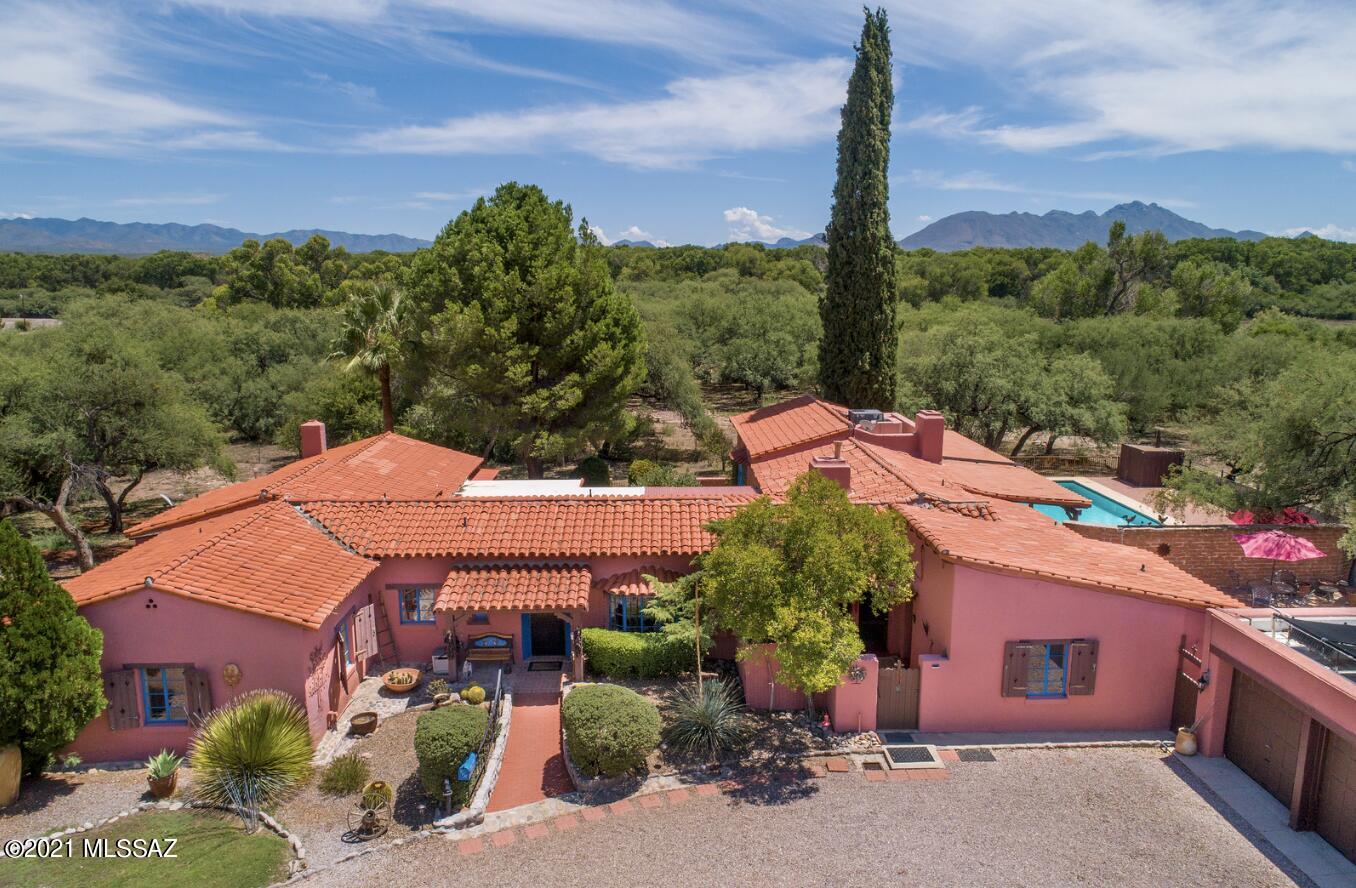 Featured in the 2019 Tubac Tour of Homes, this beautifully restored 1936 adobe ranch home welcomes you with charm and character. From the dramatic living room with exposed hand-hewn beams to the delicate painted touches around the curved windows and doors, you will be transported to the grandeur of an earlier Southwest. Bordering a 160 acre preservation area & nestled in a mesquite bosque close to the Santa Cruz River, this home is 4 blocks to the 'best small art community in America' of Tubac.This 5.7+/- acre gentleman's ranch is steeped in the history of the area. Other notable features that make this beautiful home so very special include a dining room with beehive fireplace, a sitting galleria, a wonderfully tiled kitchen with contiguous butler's kitchen, master bedroom with office and two ensuite guest bedrooms. Located close to the house are three additional guest casitas - two with cooking facilities.This property also includes a large pool with two inner courtyards, ramada, 7-person hot tub, gazebo, labyrinth, and private walking path to the Anza trail. A fabulous place to call home. Home is currently used as an Airbnb