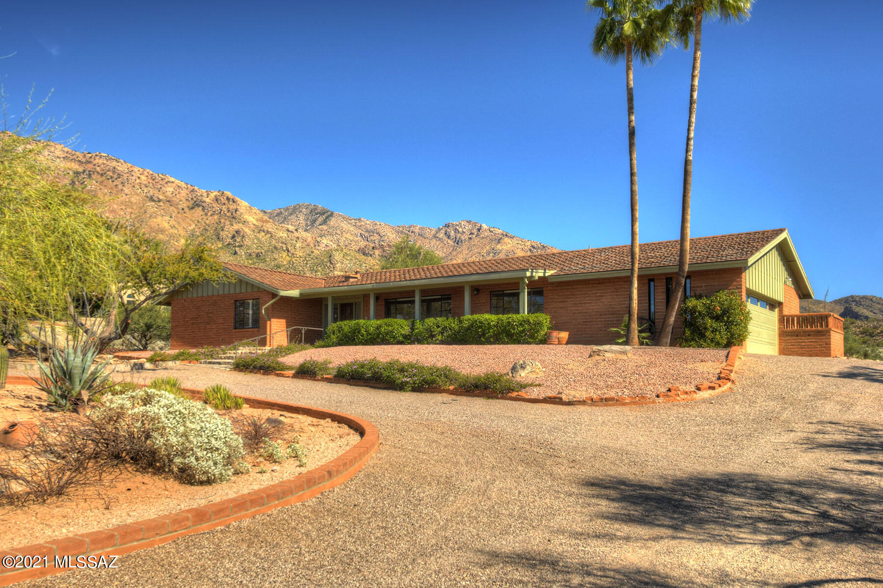 Welcome home to this classic ranch style beauty located in the sought after community of the gated Skyline Country Club. Home is situated on almost an acre and is surrounded by natural desert with gorgeous mountain, sunrise, and sunset views. You will have ample living space with formal living room and private dining. Primary Bedroom has en-suite bath, beehive fireplace, it's own secluded patio and separate study; great for a home office. Large kitchen with pass-thru window, a separate family room with fireplace, French doors that lead to the terrace, and a built-in BBQ, all make this home perfect for twilight entertaining. Remainder bedrooms are a gracious size and there is an additional full bath and half bath for guests.