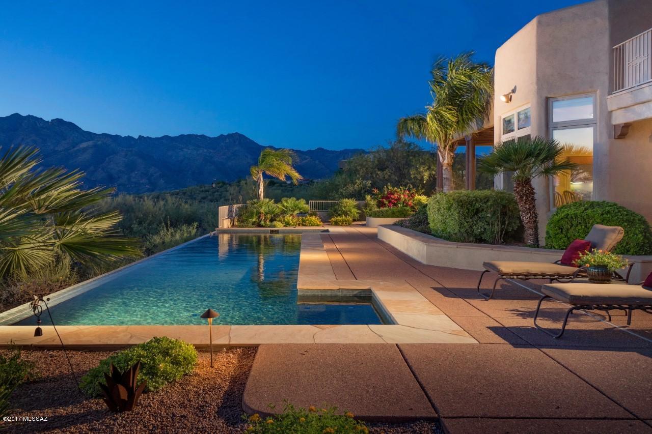 A Marriage of Luxury and Comfort in a Spectacular Foothills Setting.  Model Perfect Inside and Out. Updated Kitchen with New State-of-the-Art Appliances, including Dacor Gas Cooktop. Gourmet & Gorgeous!  Sweeping Views from every angle.  Big Windows and Doors Seamlessly Blend Interior & Exterior Living. Negative Edge Lap Pool, Dining Terrace and Deep Aggregate Patios & Courtyard. Lofty Ceilings and Clean Lines Provide a Modern Aesthetic. Spacious Upper Level Loft or Family Rm w/wet bar, bathroom and Viewing Terrace.  Perfect for Entertaining or everyday Family Living. Beautiful Master Suite on main level with separate Den/Sitting Area and Huge Walk-in Closet. It's a Dream Home, the Complete Package.