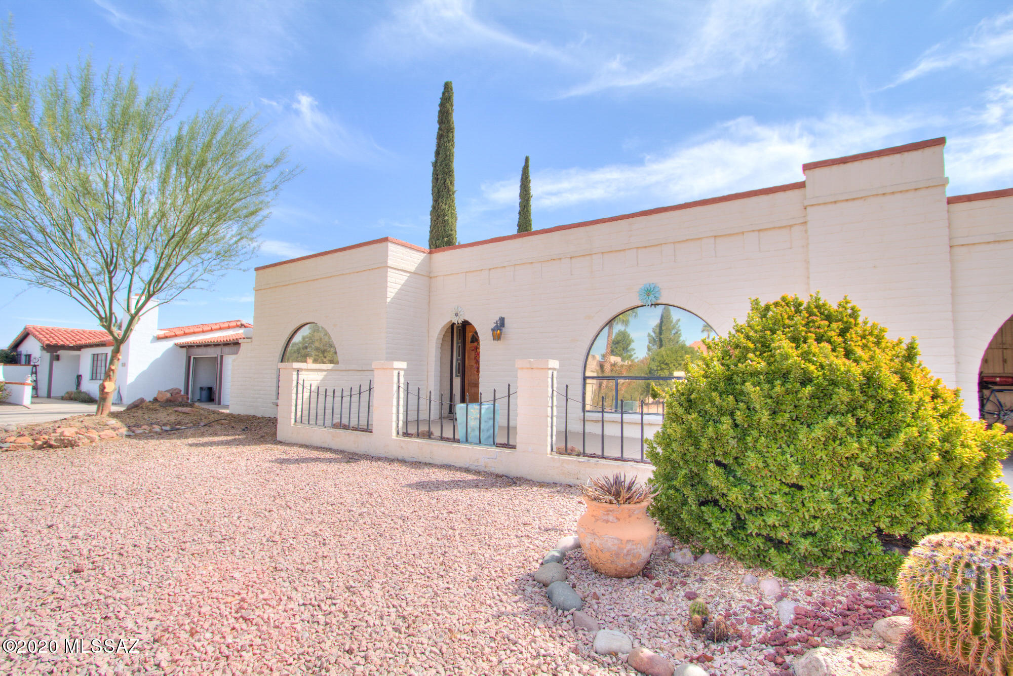 Must see this bright, updated territorial style home in Green Valley County Club Estates! This 2-bedroom, 2-bath, 1866 sq. ft. SFR has many recent updates including new plumbing, new ceramic tile & Pergo flooring, & custom wood shutters. Kitchen is light & bright w/quartz countertops, stainless steel appliances, & recessed LED lighting. Living boasts modern gas fireplace, large arched window, & lighted built-ins. Open floorplan features sunny bonus room leading to spacious laundry/utility room w/full sink. Roomy 2-car covered carport w/ample storage. Quiet lot adjacent to wash giving added privacy, wildlife & valley views. Low-maintenance landscaping w/Cypress trees, brick pavers, covered back patio w/ceiling fan for comfortable afternoons out back. This home won't last so go see it today!