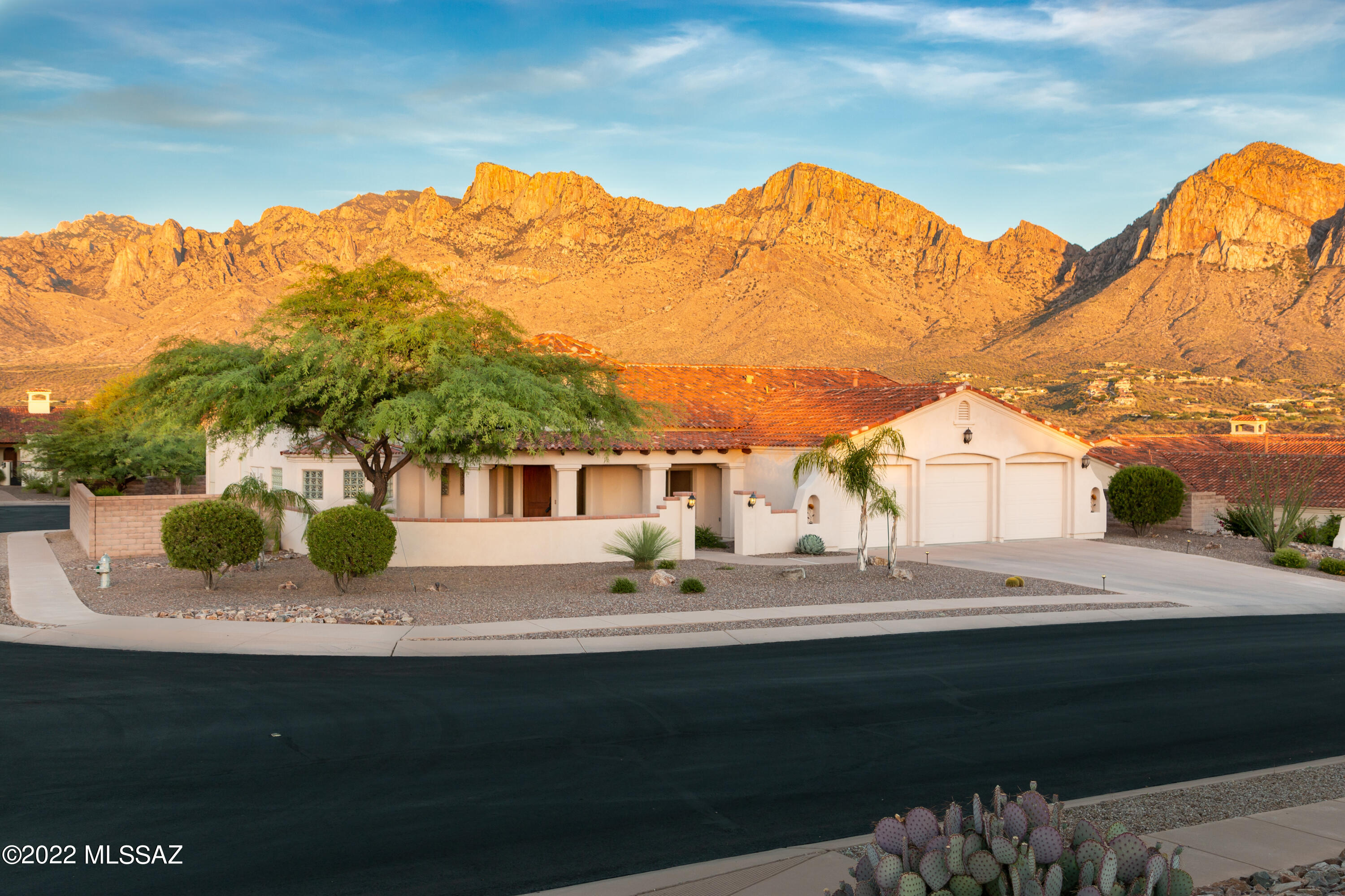 We've got the views!!! This Sombra built home is perfectly located on our great corner homesite. The results: unobstructed panoramic views of the Catalina Mountains. The homesite allows east views from the master bedroom as well as the second large guestroom and straight out from the large family room. Each bedroom room allows private entrance to the spacious covered patio. More views! The patio features built in BBQ, hot tub, room for a pool, and a cozy firepit. The large master bedroom features a fireplace, shower, tub and walk-in closet. The Chef's kitchen features slab granite, 5 burner gas cooktop and 42'' hickory cabinets and nice pantry. View fencing and brick wall provide great privacy.