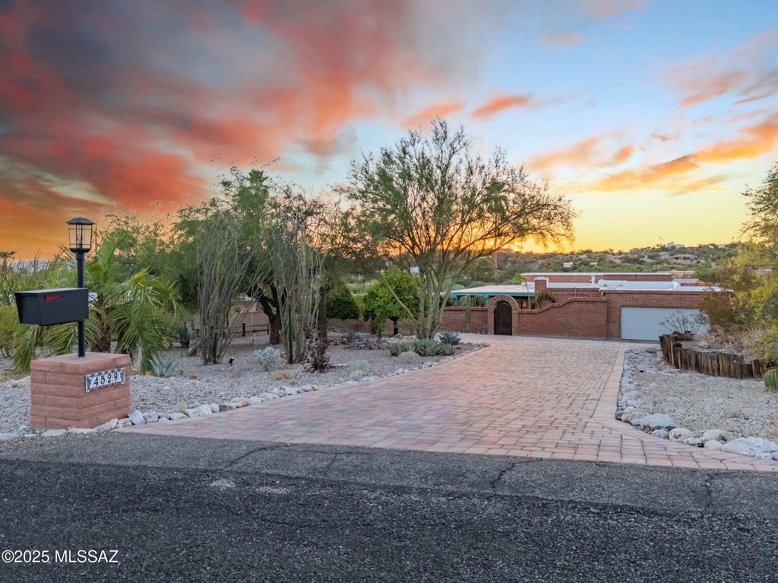 Rare opportunity in Sunrise Presidio Village. Impeccable 4 bed, 3 bath home, unobstructed mountain/city views. Living room & patio overlook city, sunsets. Formal dining has mountain views, family room with fireplace, cherry kitchen cabinets, quartz countertops, breakfast nook. Split floor plan for multi-generational family. Award-winning primary bath featured in Tucson Lifestyles. Plantation shutters, custom window coverings. Tile/carpet, 2-car garage, electric vehicle charging, engineered paver driveway, outdoor seating areas, large covered patio, cozy private fire pit. Heated pool w/power track cover. Extensive mature landscaping. Set back on cul-de-sac, private enclosed yard. Near Sabino Canyon, the Loop, dining/shopping. Excellent layout for entertaining and private enjoyment.