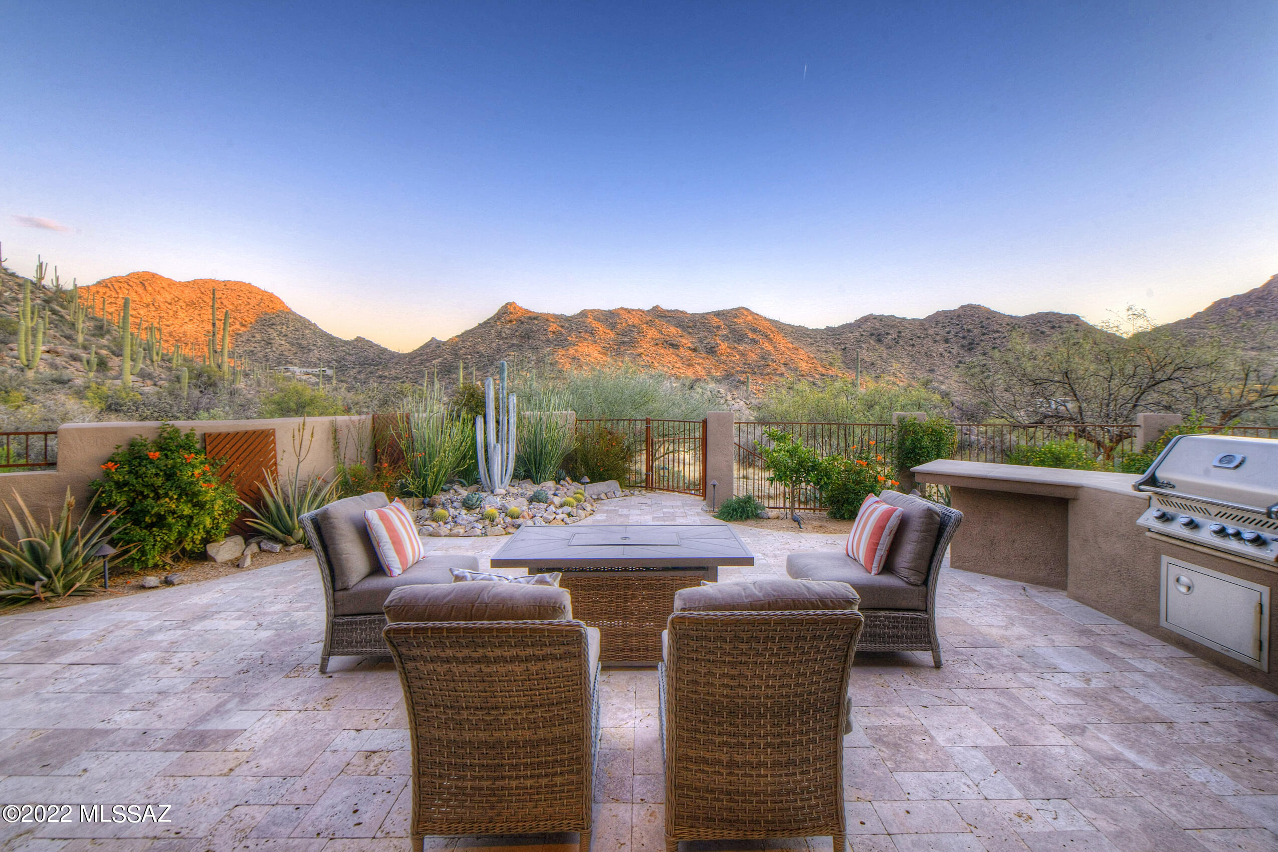 Nature & Canyon living merge to create the rare opportunity to own a true lock & leave desert modern home located on a 1-acre premium view lot in guard gated Canyon Pass in Dove Mountain. Minutes from the Gallery Golf Club & the Ritz Carlton Dove Mountain, this is best of desert living. Enjoy sensational sunrises from the south-facing travertine patio w/exceptional, unobstructed mountain & canyon views. This 2014 built home is situated far off the main street w/ driveway lined in pavers that leads to a front courtyard w/ stone accents & oversized 3-car garage w/ copper metal garage doors. Upon entry you are greeted w/ high ceilings & a palette of desert modern colors, materials & finishes that allow the wall of windows capturing the outstanding mountain views to take center stage. Highly functional & efficient split bedroom 3 bedroom plus den/ 3 bathroom floor plan w/ 2850 sf is the perfect size for working from home, hosting guests & enjoying the beauty of the desert. Office den can be used as a 4th bedroom. Modern chef's kitchen w/ center island, breakfast bar, gas stove w/ pot-filler, granite counters, SS appliances & custom cabinetry is open to the great room w/ gas fireplace. Great room & kitchen area flooded w/ natural light by large windows & flow to the dining area then directly to the deep covered patio & outdoor built-in gas BBQ grill in a with stone and travertine island. Mountain views from every room in the house. Powder room for guests. Spacious master suite designed for maximum views has spa-inspired bathroom w/dual vanities, soaking tub & separate European style shower with 2 heads. Additional 2 guest rooms are anchored by a flex-space for additional TV area or a bonus area to use as you see fit. 3rd bathroom w/ dual sink vanity & large shower. Excellent possibility for new owners to build their dream infinity pool with unobstructed views of the entire canyon. Beautiful mature desert plantings compliment this home that is surrounded by saguaro-studded hills. From the fenced back yard, theres a staircase that takes you down to bottom of the acre back yard and a pleasant stone bench/ shaded tree for relaxing. Walking distance to Canyon Pass' own private hiking trail which is crowd free with amazing views. This home is like-new condition as the ex-owner barely lived in it. Brand new exterior stucco paint and roof coating done last August with warranty. The name of the street "Brilliant Sky" properly suits this home's amazingly clear night sky views of the stars and moon.