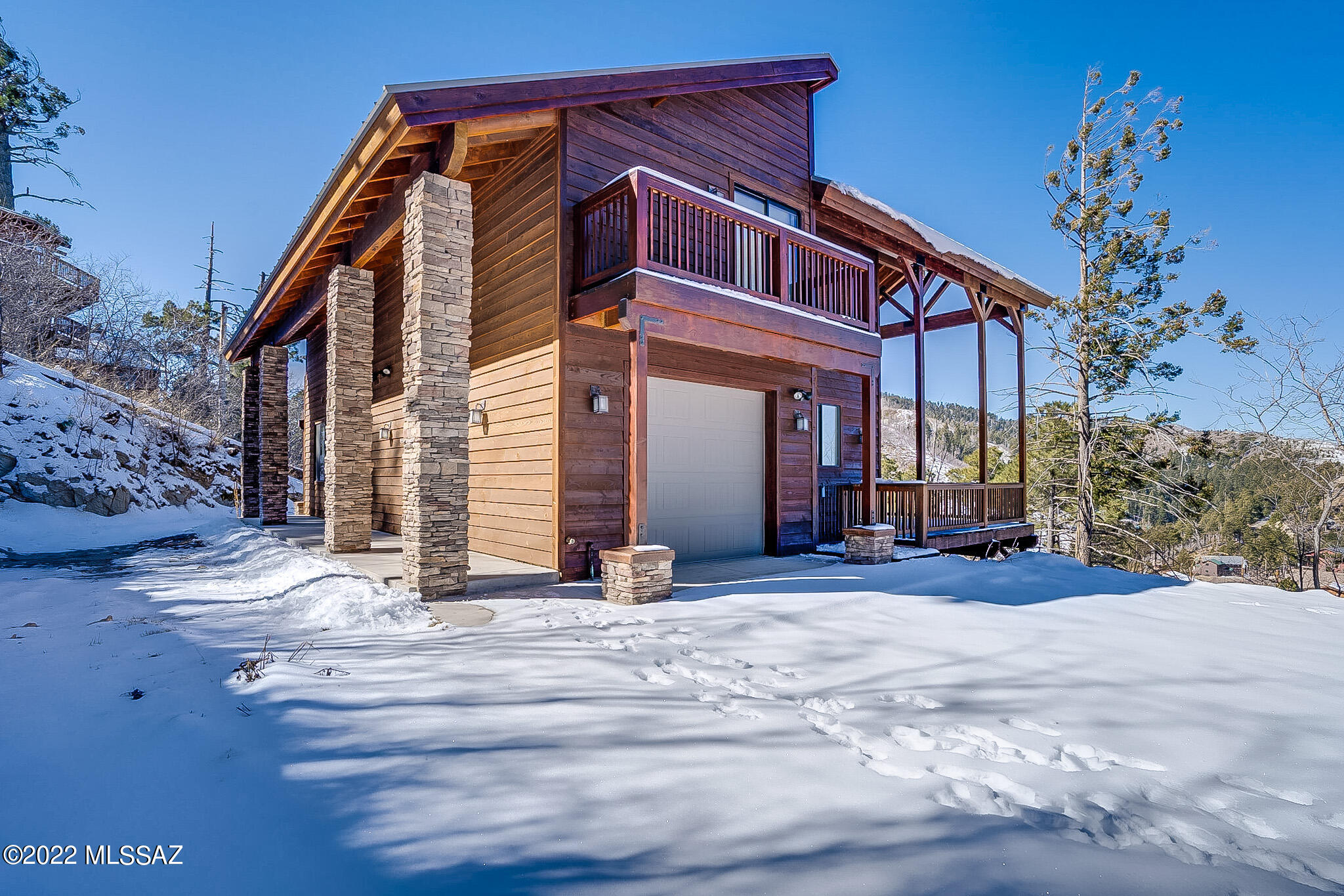 Serenity on Mt Lemmon.  Doesn't get any better than this!  Year round access.  Gorgeous 3 bed, 3 bath home with garage on 2 lots.  Large windows that bring the outdoors in.  Floor to ceiling stone fireplace in the great room.  Kitchen boasts Corian countertops and stainless steel appliances.  Loft are can be used for office or additional sleeping space.  2 identical owners suites each with private bath and balcony. Huge finished basement with bedroom and outdoor access to patio.  Central AC and 12 inch insulation in celling.  Side yard has fenced in area waiting for your dog to play.  Decking wraps around to take advantage of the beautiful views.  No details were overlooked in this meticulously maintained home.