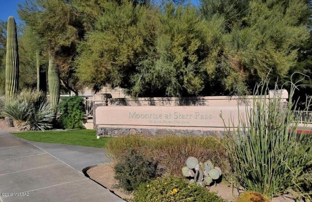 Beautiful ground floor unit in the desirable Moonrise at Starr Pass Condominiums. 2 bedroom 1 bath unit, 18 inch porcelain tile throughout, granite countertops, all stainless steel appliances, newer refrigerator. Large living room with wood burning fireplace and stackable washer/dryer included. Enclosed gated covered patio, condo located right accross from pool and all amenities.