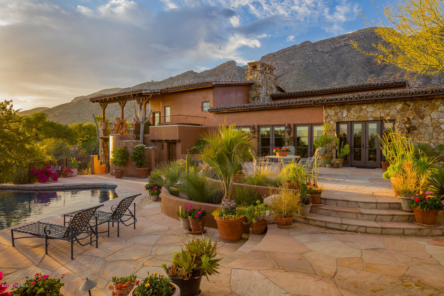 Attention to detail is an understatement for this one of a kind custom Southwestern Hacienda in prestigious gated Skyline Country Club! Fine living is the standard, from the stunning views of the Catalina mountains and city lights to the gorgeous waterfall pool overlooking the golf course, you'll have it all in this home. Walk through the antique Spanish doors and onto the Santa Fe white oak plank floors. Enjoy drinks in front of the massive stone fireplace with mesquite wood mantel under the vaulted wood timber ceilings. Treat your family to holiday meals prepared in the chef's kitchen, complete with commercial grade appliances. This 4 bdrm/5bath home features guest quarters with full kitchenette. Enjoy the award winning designed pool, flowing waterfalls and the sprawling flagstone patio.
