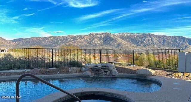 This meticulously remodeled home features modern upgrades including ceramic plank flooring, new stainless appliances, remodeled bathrooms, and new lighting, blending style and functionality. The spacious floor plan boasts an open area ideal for gatherings and relaxation, all framed by stunning mountain views. Step outside to your private living area with a built-in bbq, sparkling heated pool and spa with plenty of patio areas for stargazing and viewing panoramic mountain scenery. Newer HVAC and no steps.