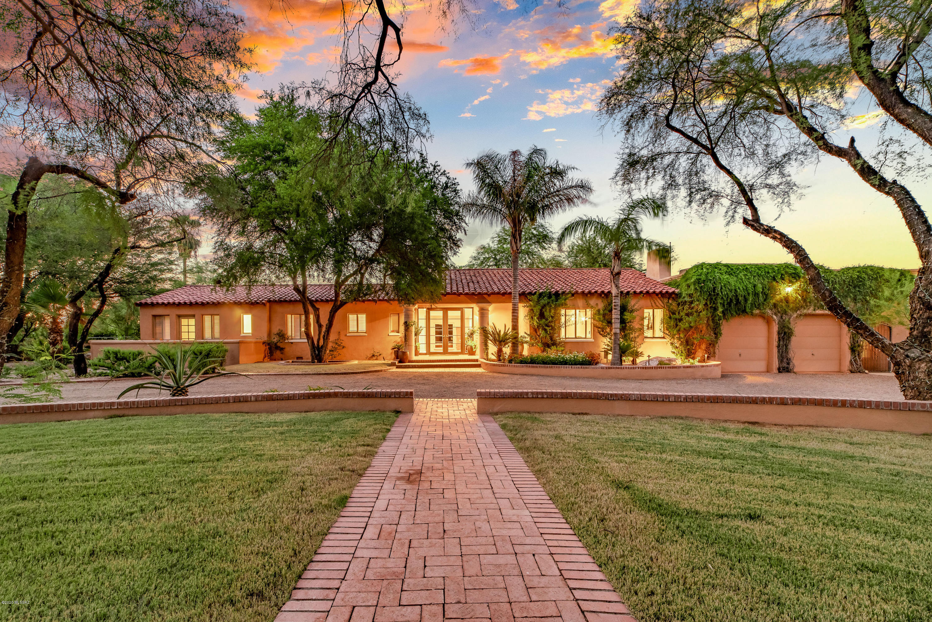 How about a staycation all year long!  Rare opportunity to own resort style home in classic Tucson historic neighborhood.  This El Encanto gem sits on a double lot and features a lagoon style pool, tennis court and lush vegetation & orchard. The home is over 6000 square feet with separate guest quarters, gourmet kitchen, home office, 3.5 car garage, expansive living room with wall to wall windows, hard wood floors, luxury master suite, with private yoga room, fabulous mater bath with dual vanity. Separate guest quarters or fitness room with sauna.
True luxury living in this mid town oasis.