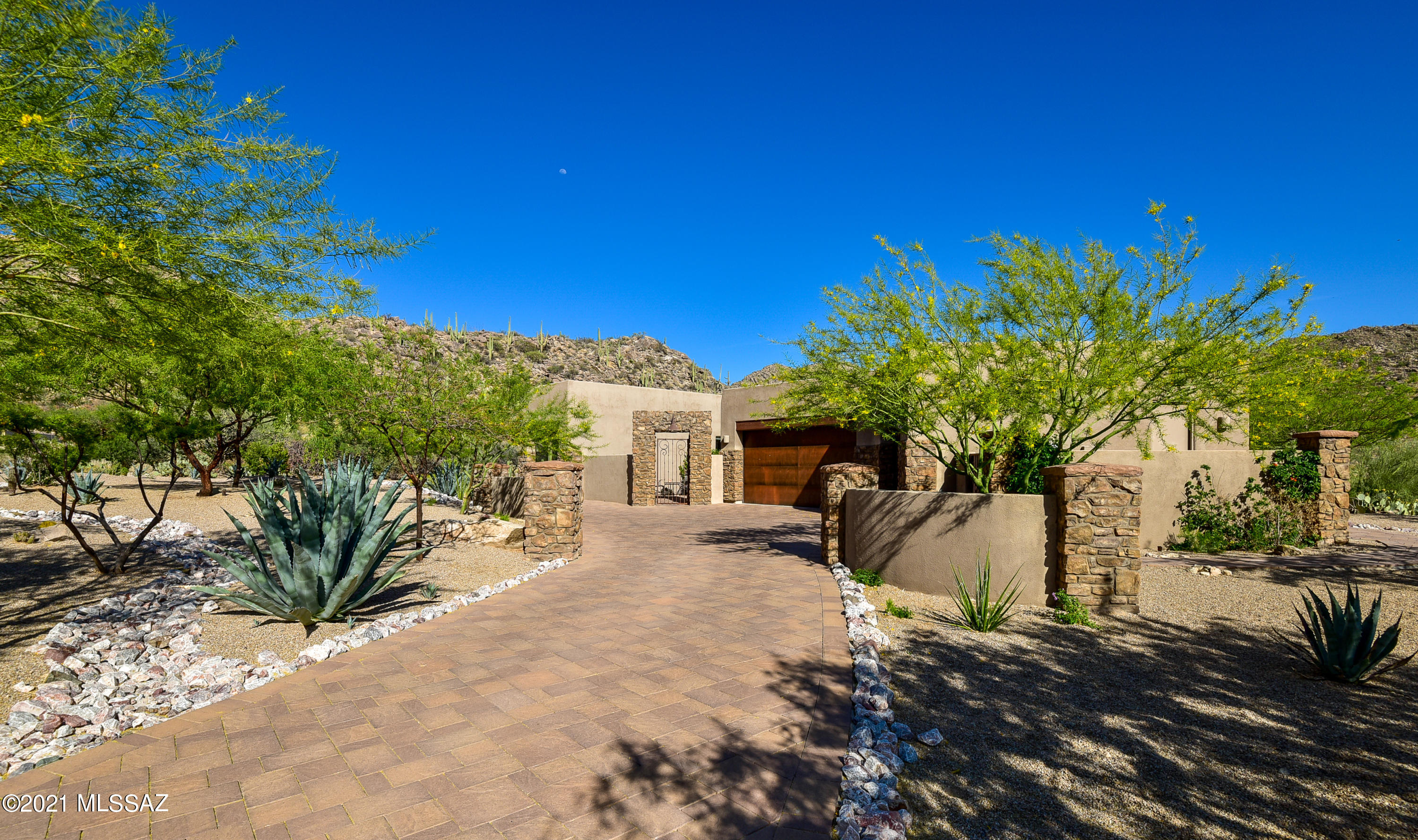 Gorgeous Mountain Views await you in this lovely Desert Contemporary home set on a well manicured one acre homesite. Enjoy the views and serene setting from your newly installed Antique Travertine patio. A great room floor plan with a new custom fireplace greet you upon entering the home. Three bedrooms and a huge den allow for a very comfortable lifestyle in the prestigious community of Canyon Pass.