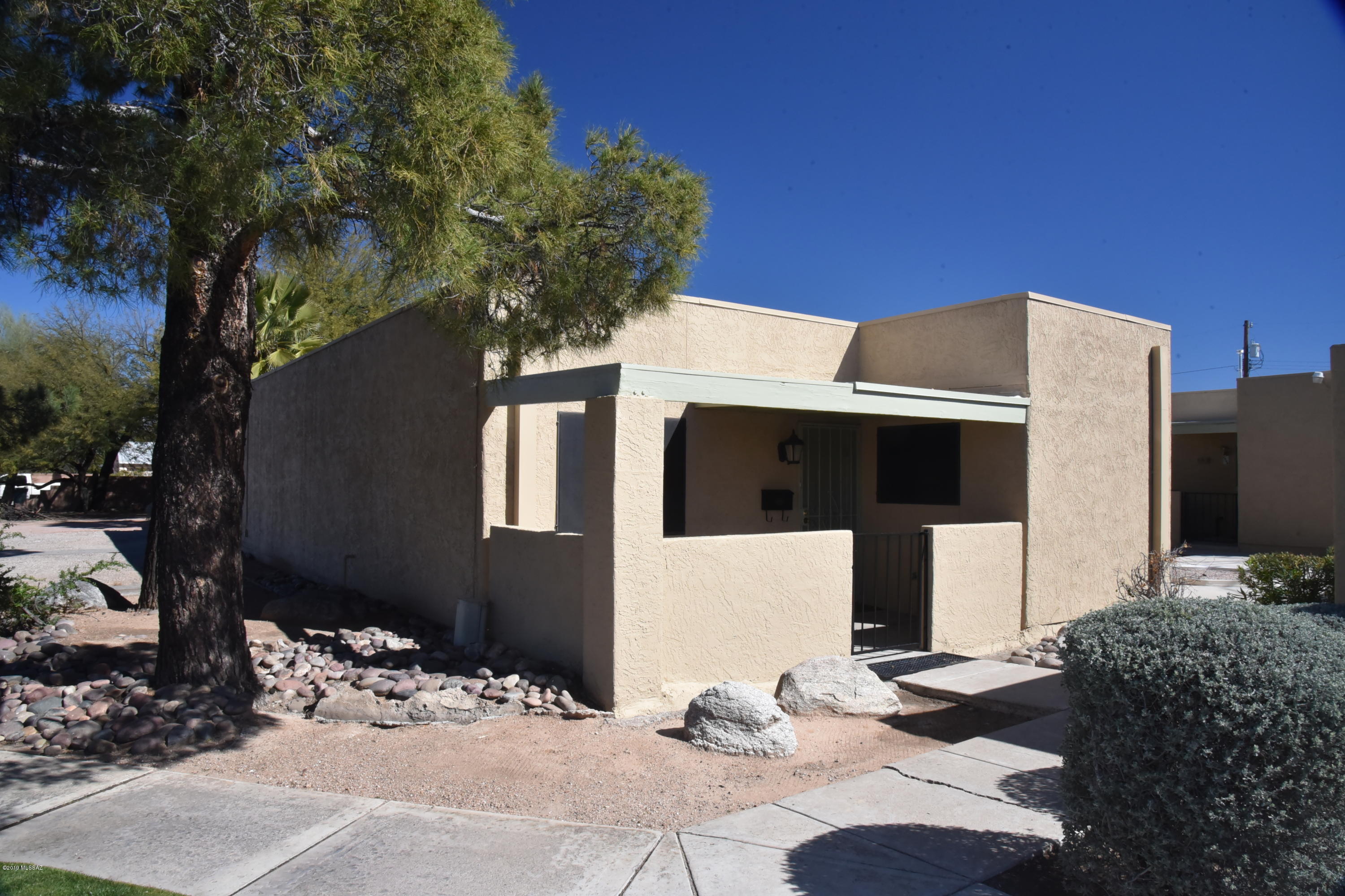 Enjoy living in this cozy ground floor condominium, situated in a private and quiet enclave of 8 Owned units (no renters) at Van Buren Condominiums.  This 2-bedroom, 2 bath, 1104 sq ft condo is equipped with stainless steel appliances, granite counter-tops and includes a bright and open floor plan with an Arizona room and enclosed courtyard.  This unit has fresh exterior paint and is only attached to one adjacent neighbor.  Centrally located and close to U of A, Botanical Gardens, Reid Park Zoo, TMC Hospital and much more.  HOA covers water, trash and common area landscaping.  This is an amazing place to call home.  Don't miss out!