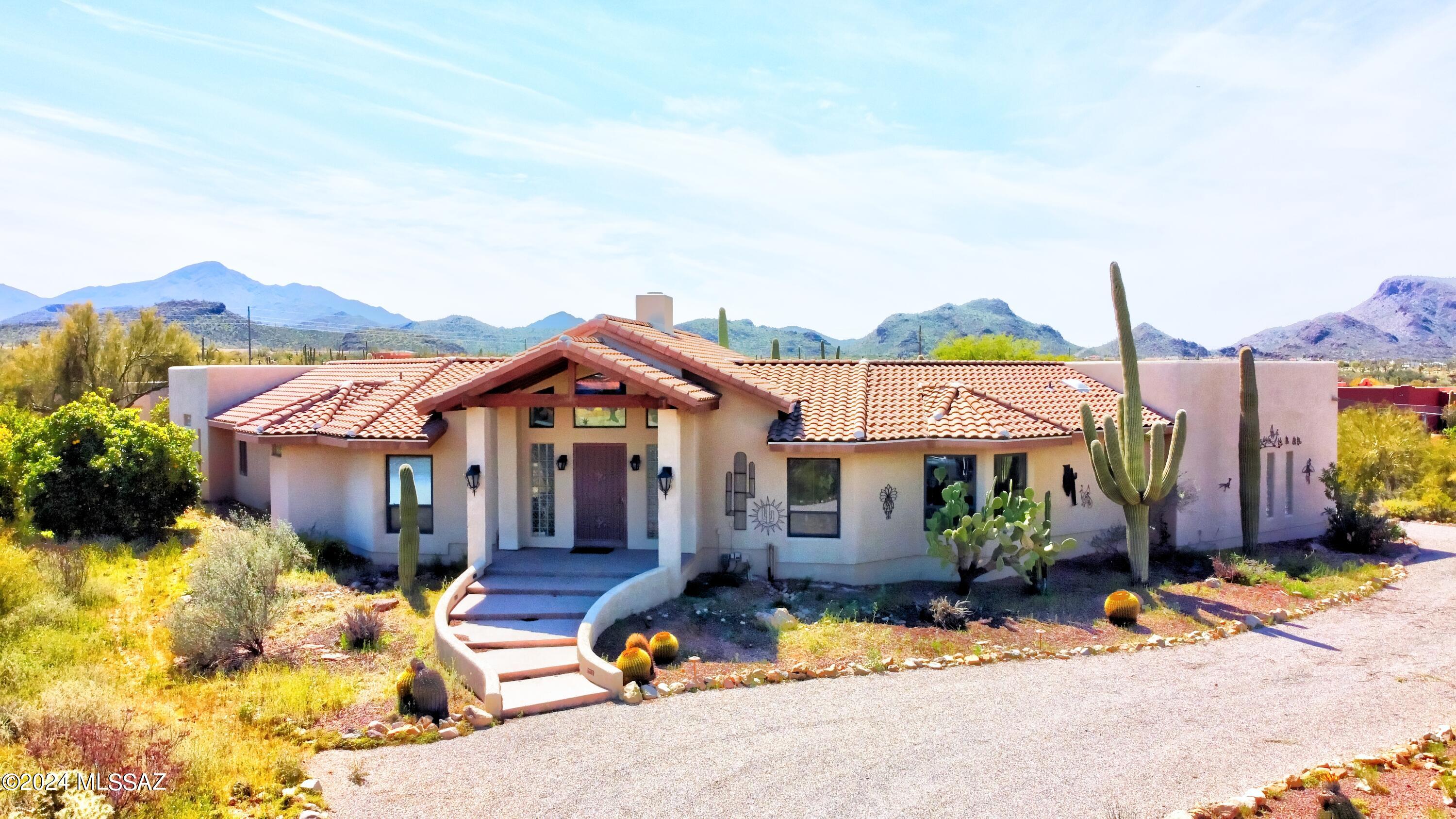 Seller will accept or counter offers between $1,175000-$1,250,000. Tucson Mountain foothills retreat on scenic saguaro studded 3.3+ acres.  Views in all directions.  Short drive to shopping and I-10.  Spacious  home with soaring ceilings and 360 degree center fireplace.  Main home is 4 bedroom, 3 bathrooms, 4 car garage, walled yard, conventional pool, enormous gourmet kitchen with extra prep sink, all kitchen appliances updated in 2016 are included. Spacious bedrooms with built in units in closets.  Master has separate tub/shower.  Home office off master suite, home theater room with light blocking blinds for ultimate home viewing.  Guest house is very private 2 bedroom, 1 bath, 2 car garage remodeled in 2017 with granite counter tops, appliances included, screened porch. See attached features sheet in additional documents.  Seller lease back possible