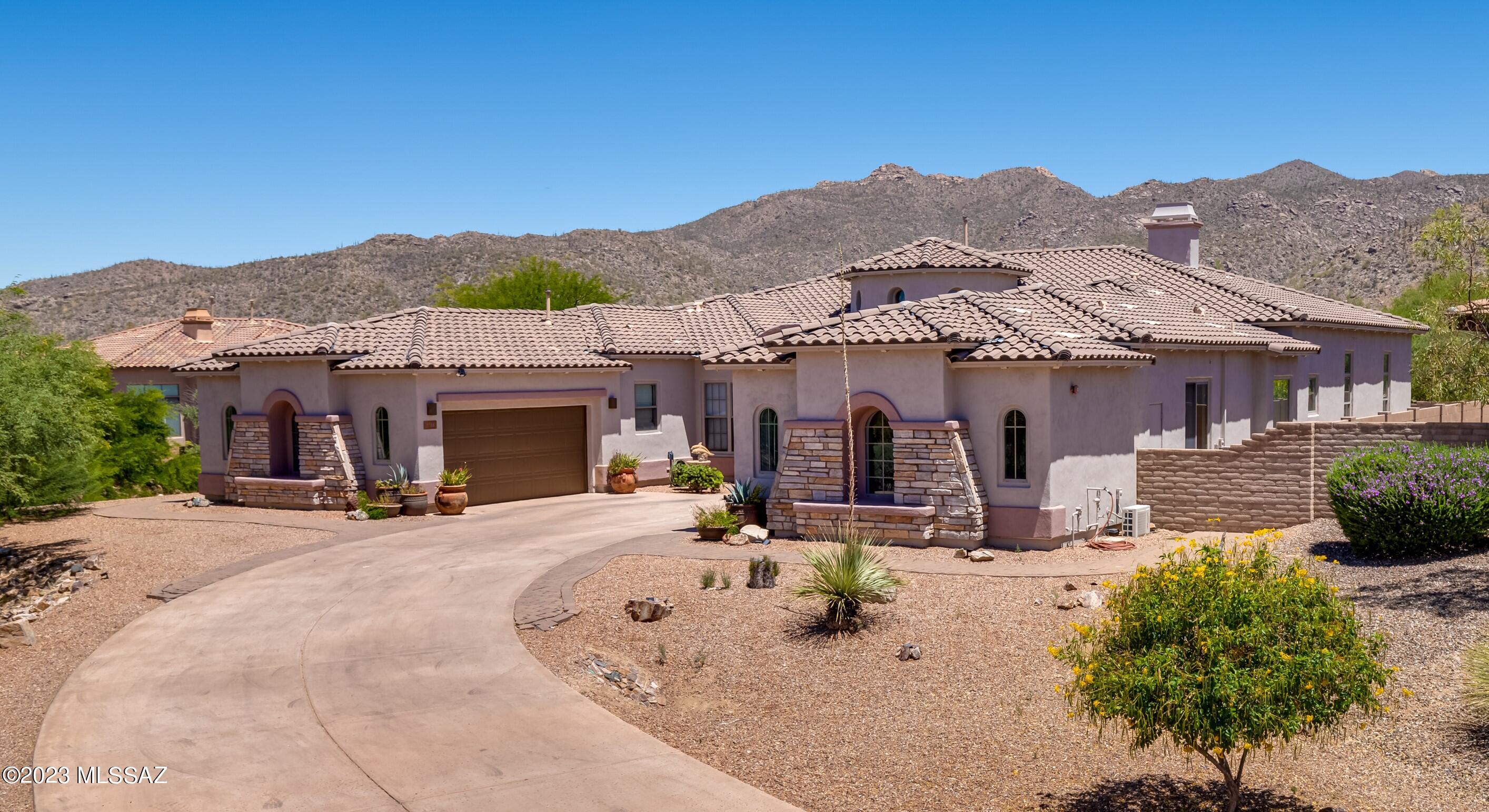 The perfect balance for everyday & extraordinary, this exquisite Toll Brothers built 4,394sf, 5BR/4½BA home situated at the end of a cul-de-sac in the luxury gated community of Solana, a world class gated golf community at The Gallery in Dove Mountain, features versatile entertaining & living options. The entry is flanked by two custom fountains. Custom Iron Security Front door opens to grand circular foyer w/clerestory windows & cathedral height ceiling. The spacious open concept floor plan alongside cozy quiet places make this home ideal for comfortable ambience & entertaining. Well-designed kitchen overlooks a bright casual dining area & offers a large center island w/breakfast bar, plenty of counter & cabinet space & sizable walk-in pantry. Recent $200K renovation includes new flooring, kitchen cabinets w/Quartz counters, glass tile backsplash, Sub Zero refrigerator, six burner Wolf Range w/griddle, two ovens, custom vent hood, pot filler, Bosch dishwasher, Built-in Wolf Coffee System & Bosch microwave oven. The great room features a dining area, fireplace & bar area w/beverage cooler & Viking wine refrigerator. Master suite has two walk-in closets, jetted tub, huge custom shower w/bench seat & access to patio. Attached Guest Casita w/private access has a kitchenette, bathroom with custom shower w/backyard access. Flush mount speakers in great room & patio. Extended covered patio & fully-fenced spacious pool-sized backyard has terraced paver stone walkways. 3-car garage. Superb location near Gallery Golf Club, an exclusive golf club featuring 36 holes of desert golf, spanning from the narrow canyons of the Tortolita Mountains to scenic landscape of the Sonoran Desert. The Gallery Sports Club offers Full-circuit state-of-the-art LifeFitness Cardio & Strength Equipment, Free weights, Olympic size lap & recreational pool, Tennis & pickleball courts & more. Access to hiking & biking trails meandering through Dove Mountain & surrounding Preserves. Experience 81 Holes of Desert Golf w/nearby Highlands at Dove Mountain, Ritz-Carlton & Gallery