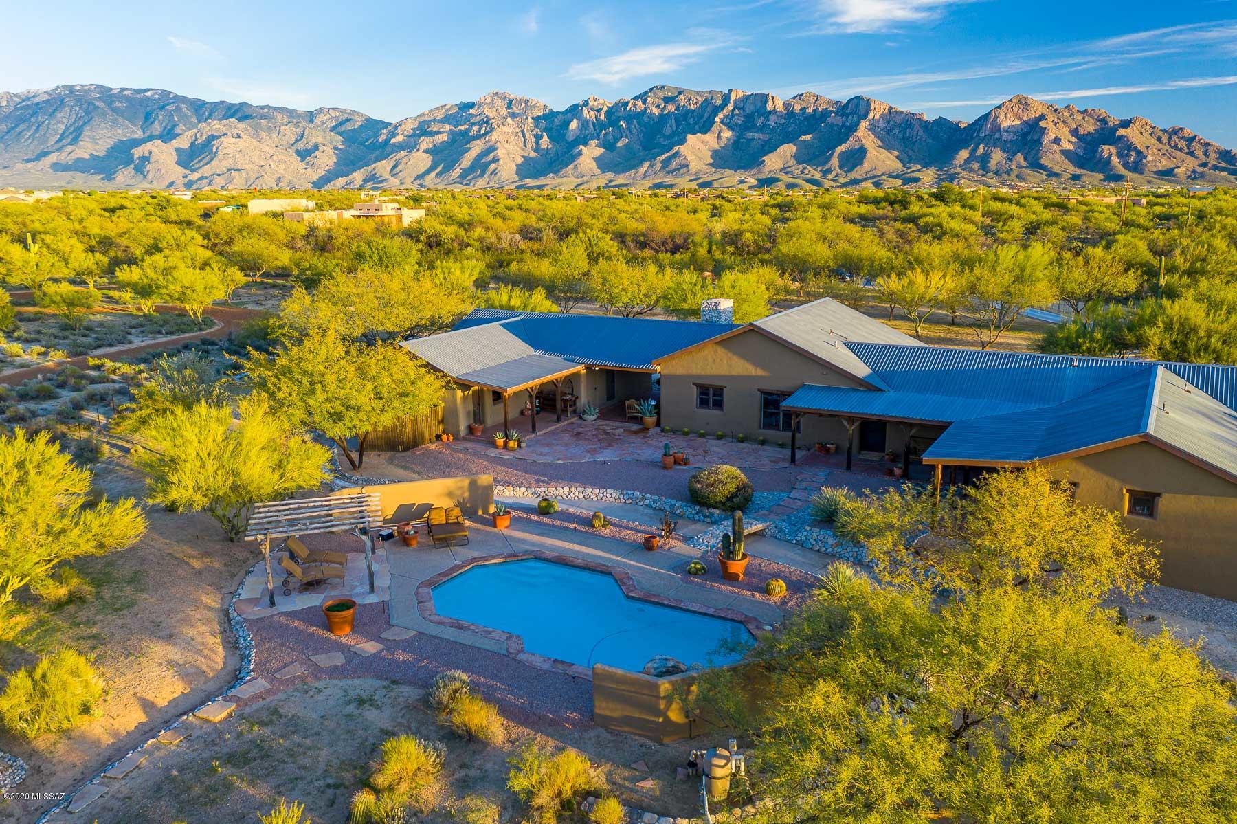 Classic Americana Gentleman's Ranch located in La Cholla Air Park. Fly in and enjoy all that Tucson and the desert has to offer!!  Main house; 3 BR,3 bath Territorial with detached 1BR,1BA 'casita' with pool on 7+AC in La Cholla Airpark. Quality is apparent with brick floors, deep sills, beehive FP, shutters, adobe walls & lifetime metal roof. Horse barn to accommodate 10+ horses. Separate garage can accommodate 6 cars plus equipment, height will allow for a lift, 2 turn out areas, round pen, full-size arena, horse exercise path, hay barn
Under cover storage and parking Turn around capability for ''Big Rigs''Approval from HOA for largest hanger to accommodate a King Aire or equivalent plane on Northside of property with easy access to streets & 4500' runway Owner is licensed agent AZ