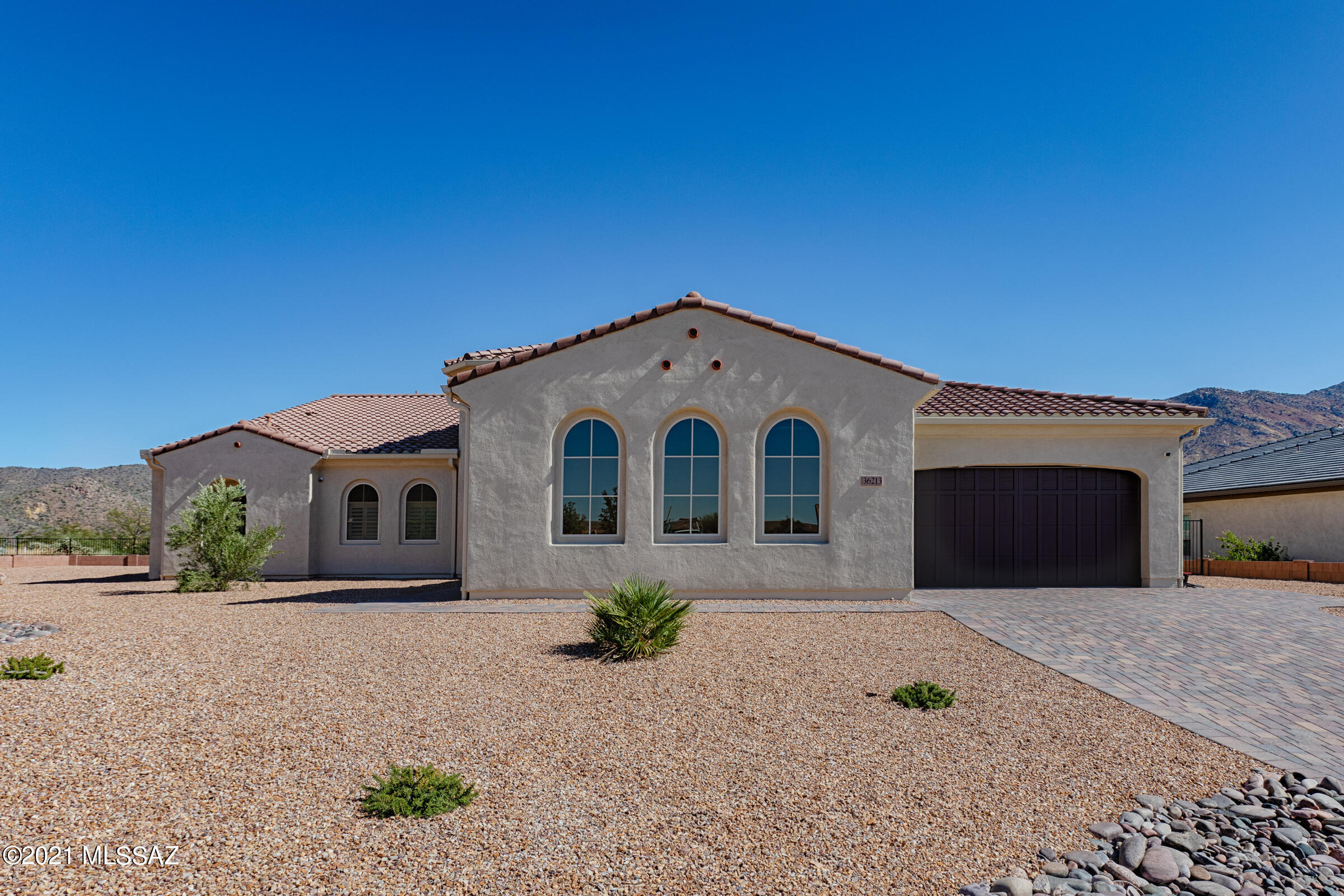 This Sonrisa Exterior Design A home is located on one of the best lots The Preserve at Saddlebrook had to offer - that has incredible un-obstructed views of Mount Lemon and the Catalina Mountain Range!  This 2-Bedroom En Suite Home includes a Powder Room; Great Room; Dining Area; Grand Kitchen Island; Media Alcove in Great Room; Walk Up Dry Bar; Oversized Den/Office; Large Walk-In Pantry; Butler's Pantry; Walk-In Linen Closet; Two Very Generous Walk-In Closets in Master Bedroom En Suite; Walk-In Closet in Bedroom 2 En Suite; Luxurious Master Bath Custom Spa Tub and Shower w/Built-In Sear and Separate Vanity; Large Laundry Room; Split 3-car Garage (this is walk-through from one to the other); 697 sq. ft. Covered Outdoor Living Space; 10' & 12' Ceilings throughout the home; Extra Storage
