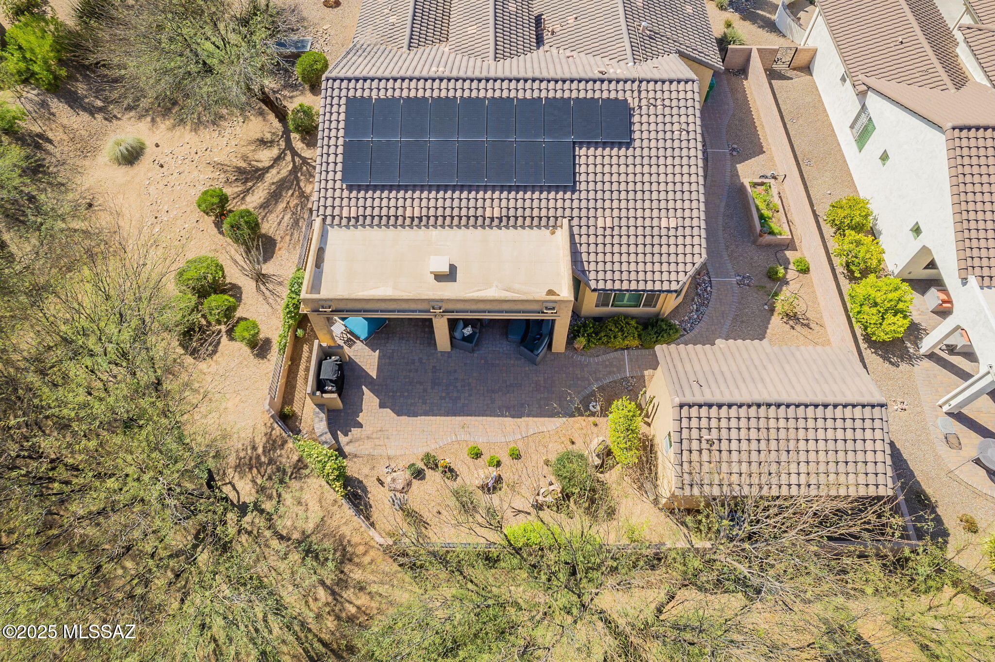 On a quiet street with a large private lot surrounded by wide riparian arroyos sits this elegant Cortez with Casita, paid solar, and extended 2.5 car garage. Start your day with coffee and birdsongs on the spacious covered patio as morning sun seeps through the trees.  A paved walkway connects the private backyard Casita and large side yard.  Inside is an open floor plan with chef's kitchen (Wolf 5 burner gas cooktop), two bedroom suites plus powder room and a large office with built-ins.  The paid solar system guarantees low electric bills. The large extended garage has a utility sink, epoxy floors, storage, and work bench.  This gem welcomes you with a front courtyard for wine and sunsets and has everything you want in a Quail Creek home: seclusion, space, solar and a big garage.