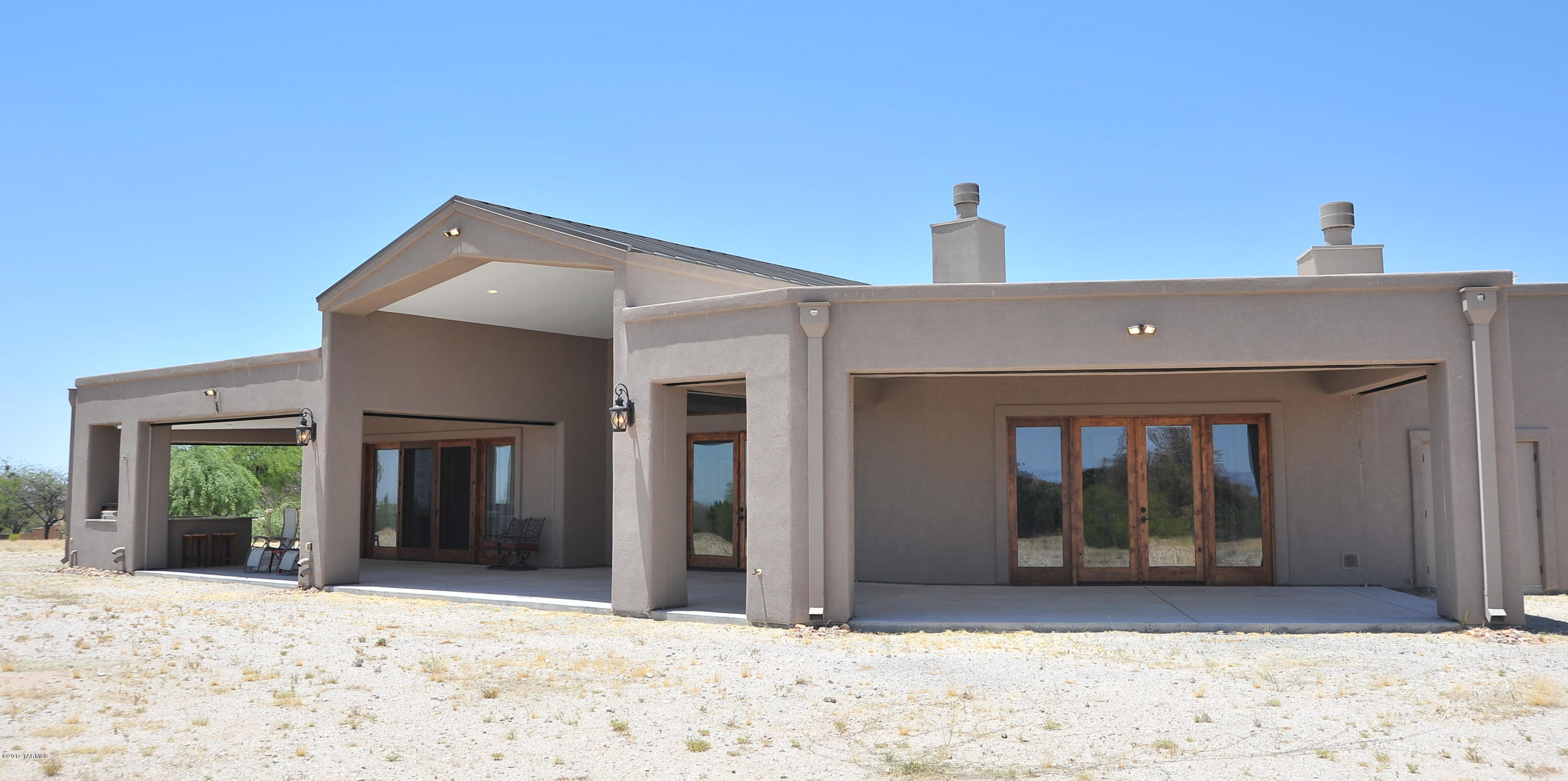 Builder lives here! AMAZING custom 4 bedroom, 5 bath 4255 sq ft behind the gate with no HOA. Just under 4 acres, horses allowed, with shared well. 50 OWNED solar panels brings the electric bill to around $20 a month! Total utilities run approx $200 a month. 2x6 construction, blown insulation, 400 amp service, LED lighting, interior sprinklers, two 50 gallon water heaters. 3 fireplaces, automatic rolling shutters on covered back porch. Custom pool & spa and outdoor kitchen to get your grill on. Great room concept with granite kitchen, 6 burner, double ovens means the holidays are at this house. 8 ft solid knotty alder doors throughout the home. HUGE bedrooms and a master closet to die for. 3 car garage with CLIMATE CONTROLLED storage. This house was perfectly built for YOU!