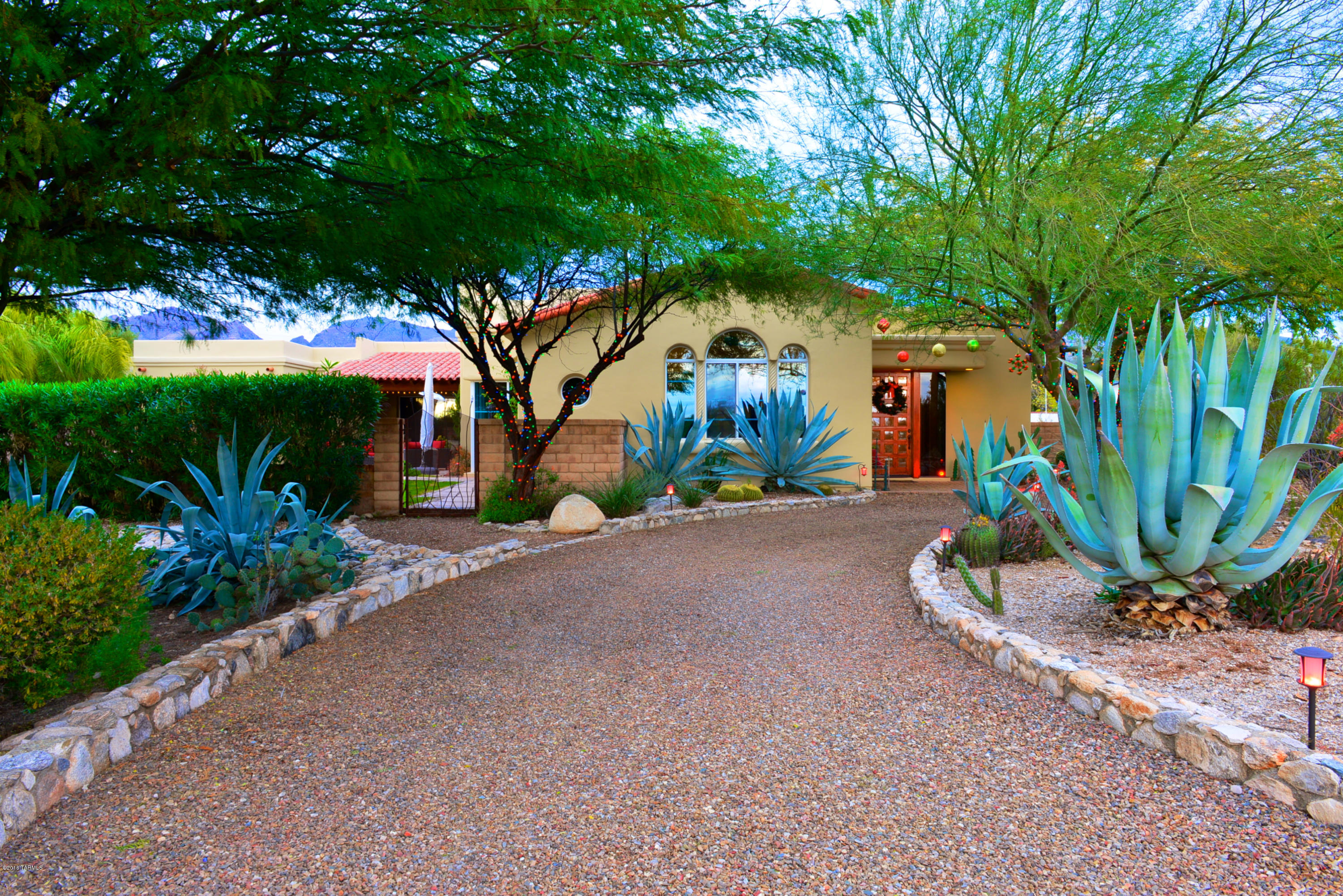 An elegant home with Southwest influences built in 2003 on over an acre with city, mountain, and sunset views.  The spacious great room features a wall of windows overlooking the yard, with its pool and spa.  The kitchen features top-of-the line stainless steel appliances, granite counters, a large breakfast nook, and is adjacent to the family room which provides a comfortable and casual living space.  The master bedroom is a retreat from the stresses of the day and features a private covered patio, two large walk-in closets, his and her vanities, a large tub and separate shower with travertine throughout.  Three guest bedrooms share a separate activity room and two baths.  The office can serve as a 5th bedroom, and the bonus room is currently used for exercise.