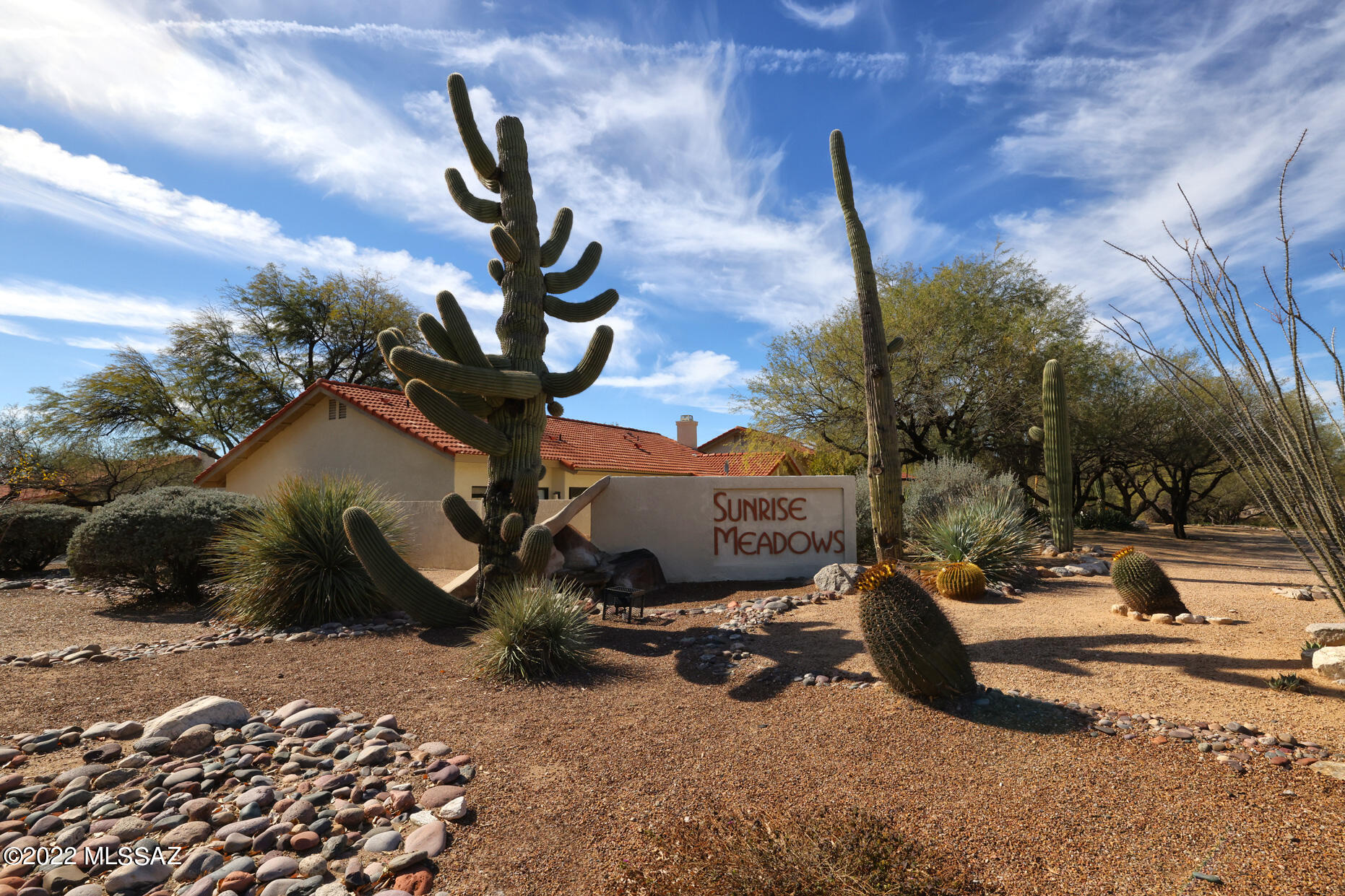 This adorable home is nestled in a mature neighborhood near beautiful Sabino Canyon in the Catalina Foothills School District. Wake up to gorgeous sunrises in the spacious backyard with a green space and mature trees just beyond the wall. Luxury vinyl floors throughout, the floorplan has two living spaces, 3 bedrooms and 2 bathrooms. This home has plenty of natural light, peak a boo mountain views from the front windows, and feels open and airy. Newer air conditioner and heater, recent roof repairs, a newer water heater, upgrades in both bathrooms, exterior has been freshly  painted, and NO POLY PIPES! HOA maintains front yard landscaping, trash/recycling, street maintenance, common areas and the community pool and hot tub area. Half a mile from Sabino Canyon recreation center!