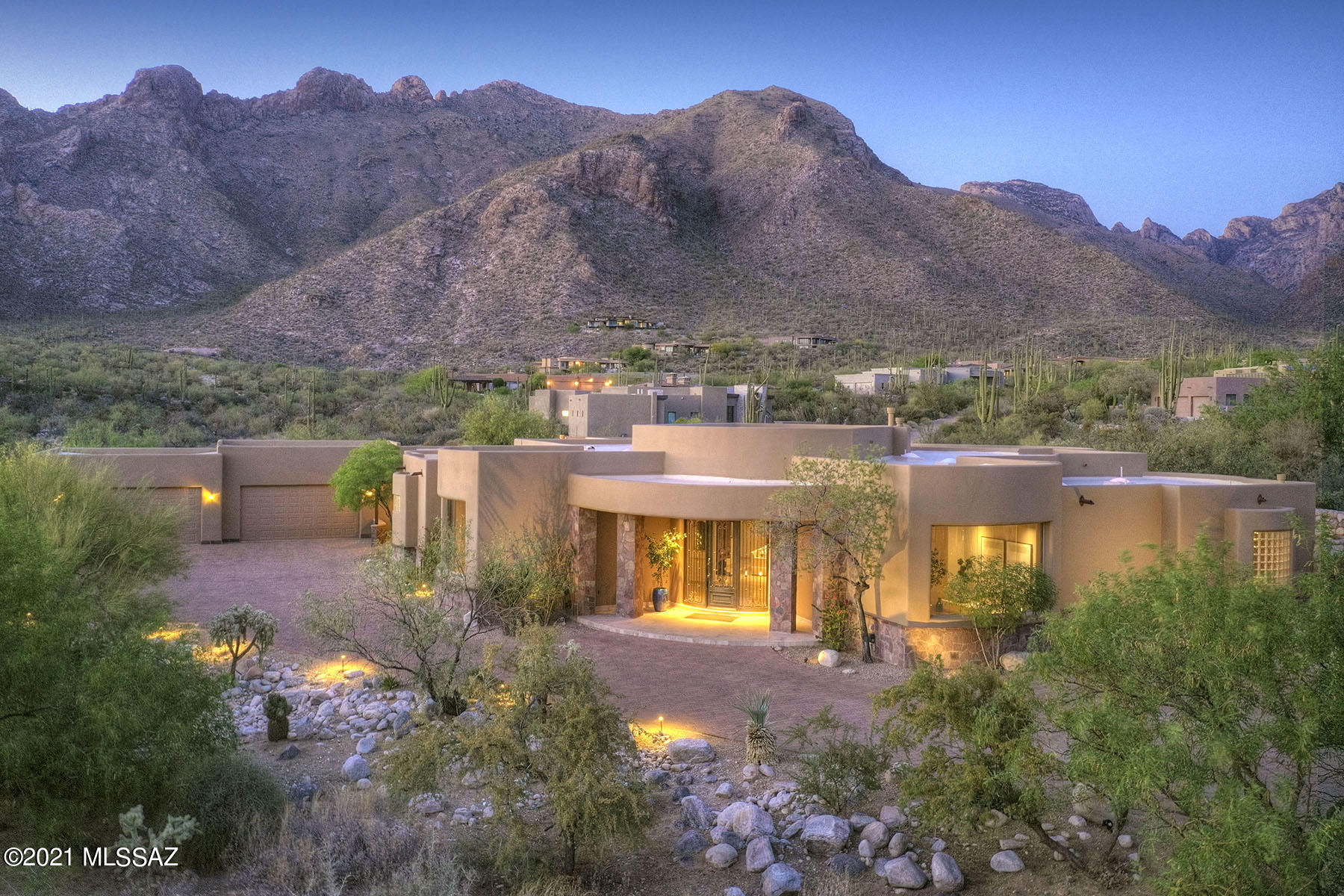 Stunning soft contemporary w/magnificent mtn views on 1.2 acres in prestigious gated Pima Canyon. Dramatic front entry w/14 ft domed ceiling, exquisite living rm w/walls of windows, fireplace, formal dining rm, lg family rm w/high ceilings, flr to ceiling windows,  travertine tile flrs,  fireplace,  gourmet island kit w/granite countertops, stainless steel appliances, Viking dbl ovens,Viking 6 burner gas range, built in refrig/freezer, walk in pantry, desk, bkfast area w/mtn views, 4 BR's & 5.5 BA's, mstr w/sitting area, fireplace, wood flrs, lux bath w/granite countertops,Jacuzzi tub, dramatic shower w/natural stone, lg walk in closet, + guest qtrs or rec rm. Resort like bkyd w/2 cov'd patios, fireplace, BBQ, pool, spa, waterfall, 4 car gar w/storage, brick paver driveway & views, views.