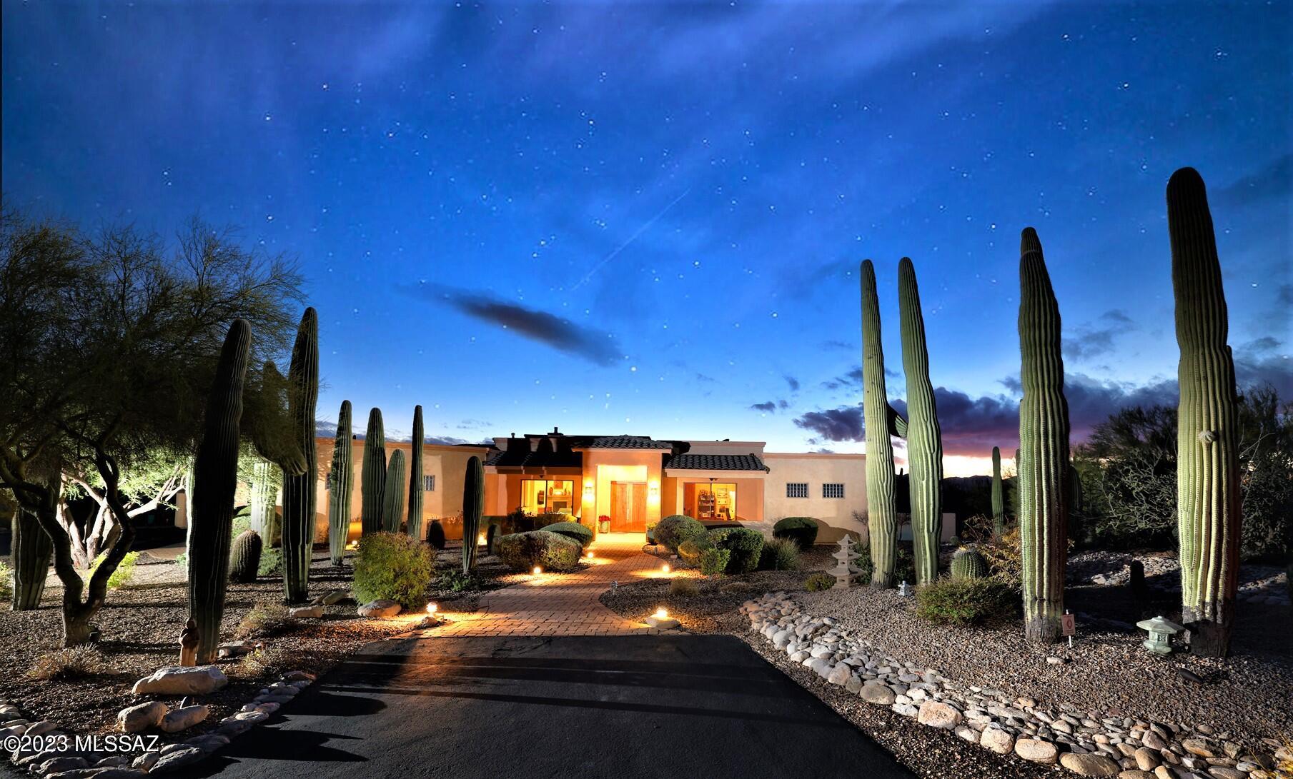 Spectacular sunset and mountain views from nearly every room are the focal point of this nearly 3000 SF home on 1.8 majestic saguaro-studded acres! Portico w/double door entry welcomes you into the foyer & beyond. Greatroom features a cozy FP, wood floors & huge picture windows. Open kitchen w/modern cabinetry, SS appliances w/gas cooktop & granite counters. Spacious dining area off kitchen, and the game room could be a formal dining area if desired. Large den/office has sliders to the front patios. Relax in the fantastic backyard w/gorgeous pool & spa, long covered patio, turf & view fencing. Generous primary w/dual sinks, walk-in shower, separate tub & big walk-in closet. 2 addl bdrms w/ J&J bath, plus full guest bath. Oversized 3 car garage w/cabinets & storage rm. All this & no HOA!