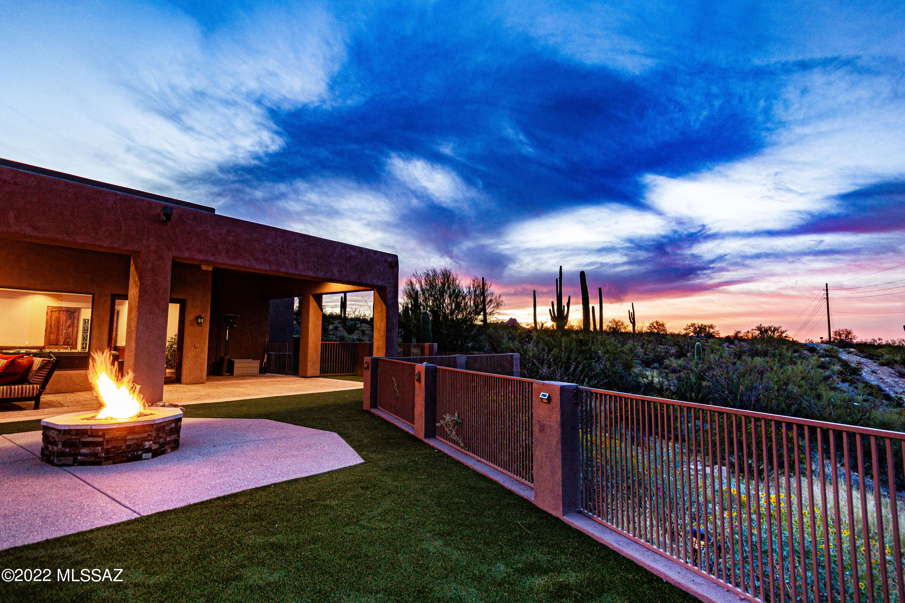 THE ULTIMATE IN LUXURY DESERT RESORT PROPERTY... 9,500 + Sq. Feet of Indoor/Outdoor Living Spaces. Perched High on a Hill, Far Above the City on 3.37 Pristine Acres, abutting Saguaro National Park, Offering Spread Out Views of the Mountains + City Lights. This Incredible Contemporary will Delight all Your Senses! Earth Elements of Water and Fire Juxtapose as a Focal Point of the Party Pool with Two Waterfalls, a 15 Foot Linear Gas Fire Line, + Swim up Bar with Gazebo and Outdoor Kitchen. Brand New High End Turf, Gas Fire Pit, and Extended Covered Patio, Flowing the entire length of the Rear Elevation, making for Effortless Entertaining. Gourmet Chef's Kitchen with Island, Breakfast Bar, Stainless Steel Themador Professional Appliances w/Gas Range & Wine Fridge Opens to Formal Dining Room. Large Primary Suite with Two-Way Fireplace. In the Primary Bath, enjoy a Luxury Spa Experience in Your Own Private Jacuzzi Jetted Tub with a Large Window Framing Views of the Mountains & Valley Below. Huge Walk-in Shower with Handheld + Rain Head. Large walk-in Primary Closet with Entire California Closet Organization system = Pure Bliss. In Addition, there is a Two-way Gas Fireplace and French Doors leading to the Patio. The Primary Suite also offers Coffered Ceilings and it's own "Mini-Bar," complete with a Wine Fridge + Granite Countertop. 

The Home offers a Split Bedroom layout with one Wing offering a long hallway leading to two Back to Back Guest Suites, both with Full baths (with showers), Laundry Room, Primary Suite, plus an additional Guest bath. 

The Living Room is Perfect for Formalities or Relaxation and Entertaining with Coved Ceilings, a Large Hearth Fireplace, and picture windows framing City + Mountain Views. The Middle portion of the house features Two Bedrooms (one with Hardwood Flooring - Great for a Home Office) and a Powder Room off the Kitchen. 

Off the Kitchen, you will find a Butler's Pantry leading to a Huge Family Room/Game Room with a Full Bar, Extra Refrigerator, + Dishwasher, Surround Sound Speakers, and 4 TV's. Perfect for Non-Stop Family Fun. Opposite the Game Room is Your Very Own Private Home Theater with a 173 inch micro perfect screen + Infocus rear mounted 1080p Projector hidden in the soffit, providing an amazing picture and sound quality. Seating for 12 in the Home Theatre. (Theatre Chairs and Drink Tables Convey). Sound comes from a 9.2 Surround Sound System with PSB Speakers and Velodyne Subwoofers. Home is Prewired for Total Home Automation, including Garages, Front Exterior, Rear Patio, and Pool. 

Speaking of Garages... The property offers the Main Garage as an Oversized 3-Car Garage with Storage Cabinets and Shelves, which leads to a Massive RV Garage with Room for an RV and a Boat, plus Hookups. No RV- you can park 6 additional standard vehicles comfortably or turn it into a full indoor Basketball Court! The RV Garage is wired for an Evaporative Cooler, and has 50 amp service with septic and water. It also has an Oversized 20 x 14 Foot Door with Remote. The Main Garage has Oversized Doors of 20 x 8 Feet and 10 x 8 Feet. All Garage Floor Surfaces are Epoxy Coated for Easy Care and Aesthetics. 

Further Bonuses: Two Laundry Rooms (one on Each Wing), Surround Sound Speakers throughout the home- including Game Room, Kitchen, Dining, Extra Front Bedroom, Office, and Primary Suite/Primary Bath. Solar Tubes. Water and Fire Features on Pool, as well as Pool Heater and Light are controlled with a Cell Phone App. There are many TV's throughout the Home, and they all convey to the Buyer. Thermador Side-by-Side Refrigerator- ice maker has a new motor. All Appliances, as well as the Patio Furniture also Convey to the Buyer. 

Structural/Mechanical: Rheem Prestige Series Quiet 80 Dual Stage Heating and Cooling. Units are 5 ton 15+ SEER rated. 3-Zoned Heating and Cooling with 7 Day Programmable Honeywell Thermostats. Two 80 Gallon Gas Water Heaters with instant hot water loops. Water Softener System. Reverse Osmosis System. Central Vac System pre-plumed and wired for entire house. 

Additional Items to Note: Landscaping is low care, due to proximity to Saguaro National Park. High End Turf in Backyard New in 2021. Flooring is Travertine Tile Throughout the Home and Hardwood in the Office. The only rooms with carpeting are the Game Room and the Home Theatre. Entire Exterior was recently repainted. Roof was Recoated in June of 2021. 

This One of a Kind Contemporary Masterpiece has all the Bells and Whistles you have been dreaming of and waiting for. The wait is over! Providing the highest level of Luxury, this property is sure to please the most Discerning Buyers, and will WOW your Guests from the Moment they arrive!