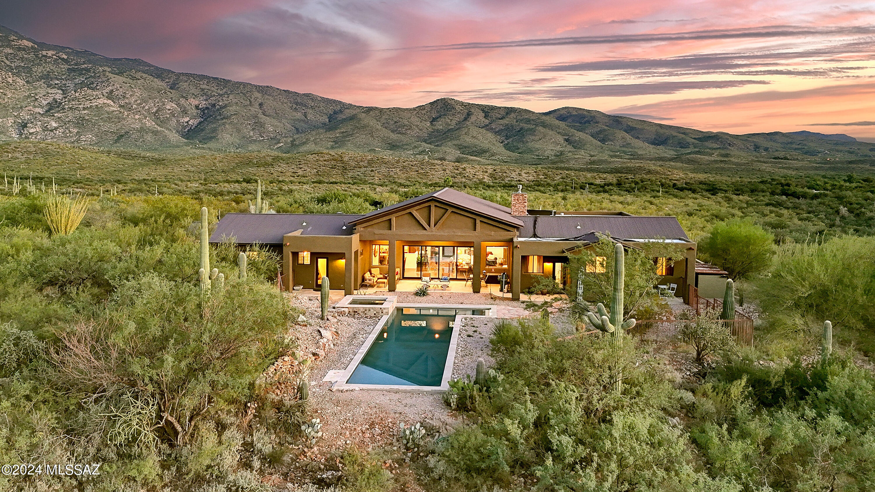 Nestled at the base of the Rincon Mtns in the exclusive X9 Ranch gated commty, this exquisite home boasts spectacular Mountain Views, unparalleled tranquility, privacy & the ability to experience nature like no other! Dramatic sliding glass windows perfectly frame the Rincons, overlooking the sonoran desert & your own oasis complete w/lap pool/spa & huge cov'd patio. Rustic exposed beams, concrete flrs, solid wood drs, high ceils & gas FP. Chefs kitchen w/Viking gas range, dbl ovens, spacious island & SS appl. Luxurious primary has private patio to outdoor living. Terrific craft rm is a hobbyists dream. Greenhouses provide a prime oppty to garden to your hearts desire.  All surrounded by abundant wildlife and a sense of serenity that can only be experienced in person to truly appreciate.