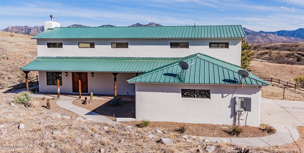 Ranch style custom home in beautiful Lake Patagonia Ranch Estates.  4.24 acre lot that is completely fenced. 2 story great room with rock fireplace and panoramic mountain views. Substantial rastra construction with metal roof, stain concrete floors downstairs & wood upstairs.  Abundant wild life and beautiful starry skies at night.  Close to Nogales & Patagonia and not far from Sonoita's wineries.  Tucson is just an hour north via I 19. Fenced pool and horse facilities.