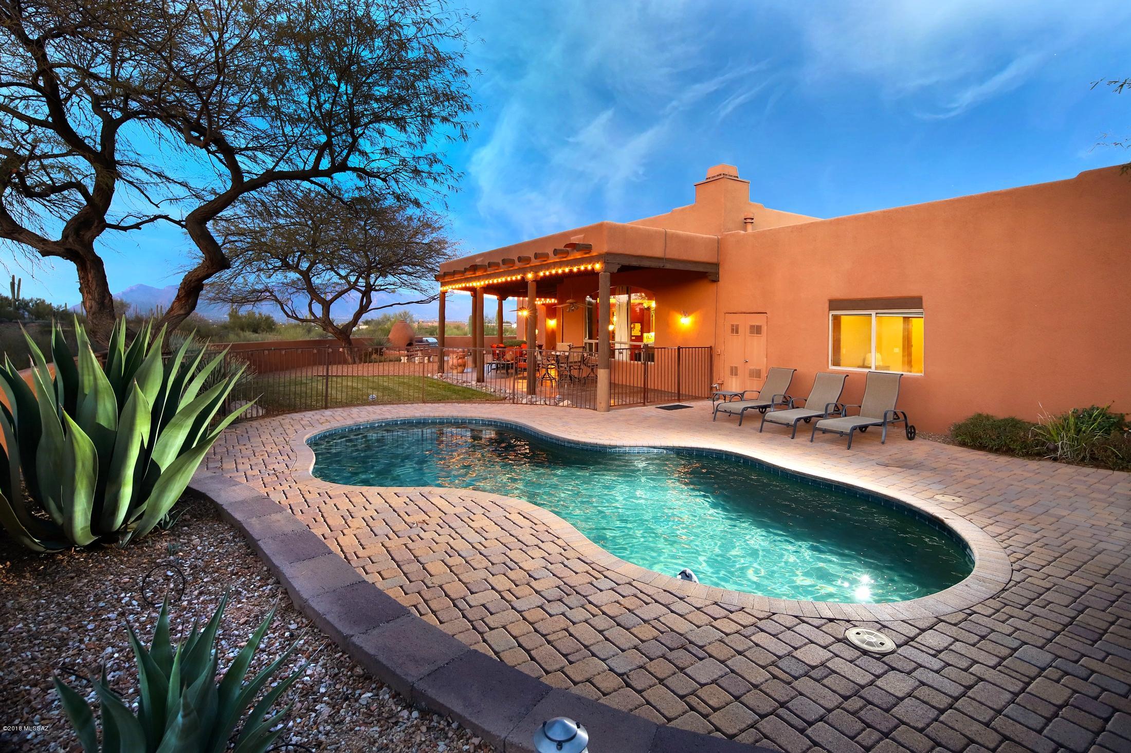 WELCOME TO THIS STUNNING SOUTHWEST SOFT CONTEMPORARY ESTATE WHICH BOASTS 4 BEDROOMS, 4 BATHROOMS, 2 SEPARATE LIVING AREAS, AND A HOME OFFICE AT NEARLY 4,200 SQFT. WITH PLENTY OF ROOM TO GROW AND OUTDOOR LIVING SPACE, YOU WILL BE ABLE TO ENJOY TUCSON'S LIVING AT ITS FINEST. THE GOURMET KITCHEN FEATURES HIGH END APPLIANCES, BREAKFAST NOOK AND SEPARATE FORMAL DINING ROOM. HOME FEATURES INCLUDED NEST THERMOSTATS, EFFICIENT HVAC SYSTEM, HIGH CEILINGS AND SPARKLING POOL. THE MASTER SUITE FEATURES A FIREPLACE, SITTING AREA, AND SPACIOUS WALK-IN CLOSET. STEP OUTDOORS TO APPRECIATE THE MAGNIFICENT CITY AND MOUNTAIN VIEWS IN THE THOUGHTFULLY LANDSCAPED BACKYARD.