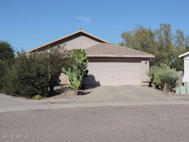 Here is your opportunity to own this open concept ready to move in spacious 1495sf, 4 bed, 2 bath home with a 2 car garage. The home offers a spacious kitchen that opens to the family room. Also has a large dining area, with breakfast bar plus vaulted ceilings. Enjoy the large master suite, walk in closet and spacious master bath. Relax in the low maintenance yard with covered patio. Newer paint, carpet and tile. Home is close to shopping, city parks, U of A, Davis Monthan, and highways. This home is a must see and priced to sell today.