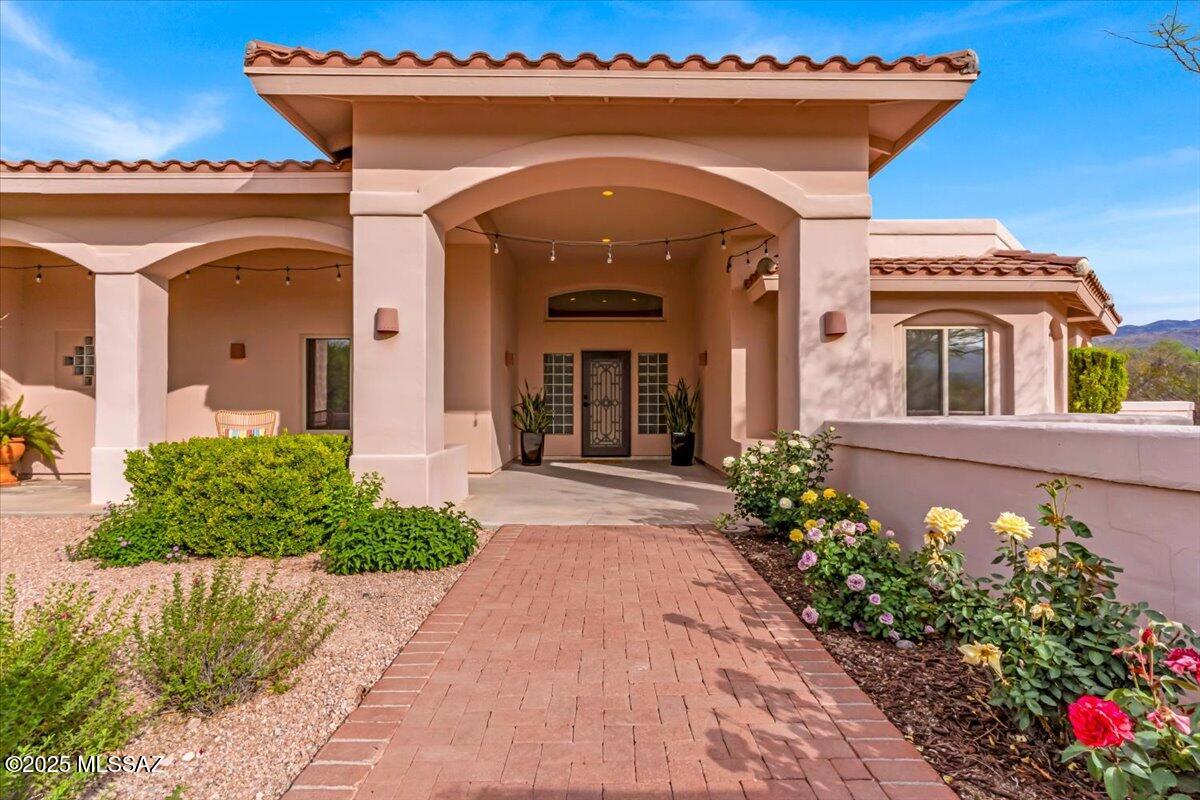 This spectacular 2945sf 4 bed 3 bath Mediterranean beauty is located in desirable Sneller Hills subdivision in the Tanque Verde Valley of Northeast Tucson.  This home offers high ceilings for light & bright formal Living Rm, Dining Rm & Living Rm off Kitchen.  Gourmet Kitchen w/Island, SS appliances, gas cook top, 2 wall convection ovens, bar seating & breakfast nook. Cozy Gas Fireplace in Living Rm off Kitchen. Owner's suite has bay window w/bench & storage, walk-in closet, dual vanities, soaking tub & walk-in shower. 4th bedroom can be used as an office/den w/custom wood built in desk, shelves & murphy bed that conveys. Expansive patio overlooking sparkling pool w/waterfall feature. Attached finished 3 car garage w/storage room. Situated on a .91 Acre Private lot on cul-de-sac.