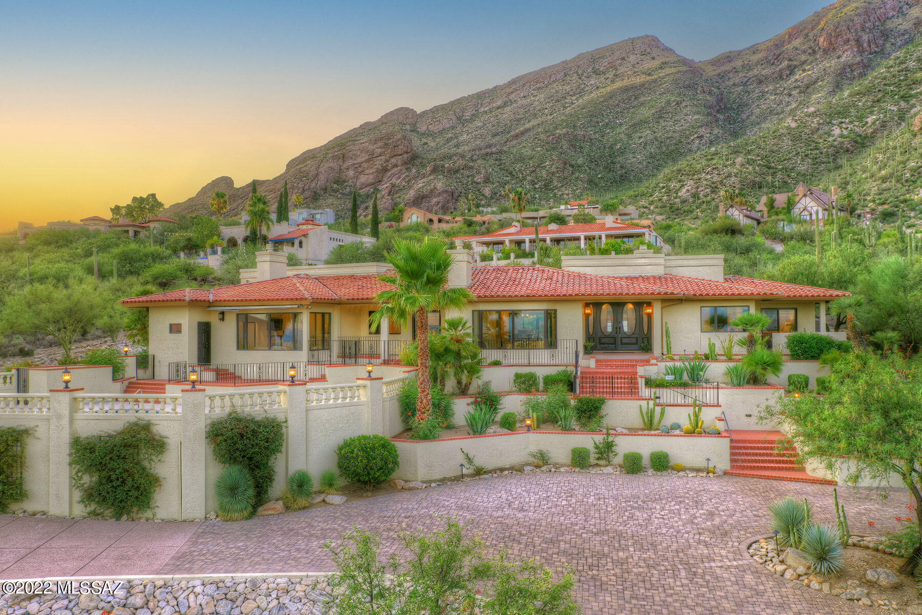 One of the finest lots in gated Skyline Country Club.  Reminiscent of a Mediterranean Villa sited to showcase its stunning architecture and capture magnificent city lights.   The 4BR/4BA main house features a living room with stone fireplace and separate dining room opening to private back patio.  The kitchen is a chef's delight with Wolfe range, Sub-zero refrigerator and huge island w/slab granite. The primary bedroom suite has a sitting room w/fireplace, private patio, bathroom that rivals the best spa w/freestanding tub and custom-tiled shower.  Adjacent to the suite is an exercise room or office.  A large family room boasts a wet bar and will be the go-to place for relaxing.  The 814 sq.ft. guest house has a full kitchen, LR, bedroom, bath and garage.  See floor plan under documents!