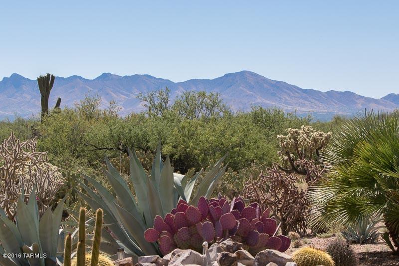 Gorgeous northeast facing rear patio that backs up to the University of Arizona Experimental Range and Majestic Mountain views. Upgraded Talavera model is easy to live in. Tons of upgraded that include bonus room with over-sized tile; wood floors in main living areas; large tile in bathrooms; stainless steel appliances, gas range, upgraded 42'' cherry cabinets in kitchen and laundry room with pull outs in most cabinets, laundry room sink and pull-out hampers, bump out bays in all the right places, surround sound, R/O system, extended garage with epoxy floor, storage cabinets, laundry sink. Outside space is a perfect spot for entertaining with a built in BBQ and water feature. Enjoy wildlife from your rear patio and the neighborhood from your over-sized front patio.