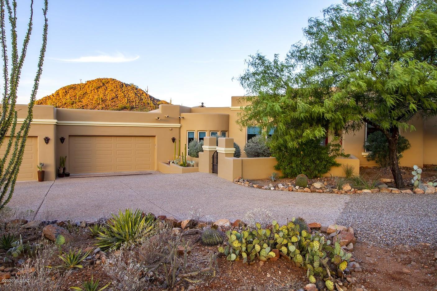 Private,Custom 4 bd/3 bth on 3.4 acres in the close in Tucson Mnts only min  to 1-10, downtown Tucson or Northwest side. From the moment you walk in the front courtyard entry, the home invites the ''outside in'' with Walls of windows overlooking the Resort like backyard, protected Mountain peaks, & City Lights. Front facing Saguaro Nat Park &  awesome sunsets! Low care colorful Backyard featuring Outdoor Kitchen, Pool/Spa (w/fiber optics lighting) Fire pit w/built in seating,  covered wrap around patio! Split bd plan, romantic master suite w/fireplace! Updated kitchen & baths with Granite Slab counter tops,spacious ''gourmet Kitchen'' w/all SS appl & off the family room. 3 fireplaces inside, one fp out! colored concrete flooring! 2 new 18 seer a/c & Furnaces. see virtual tour under photos