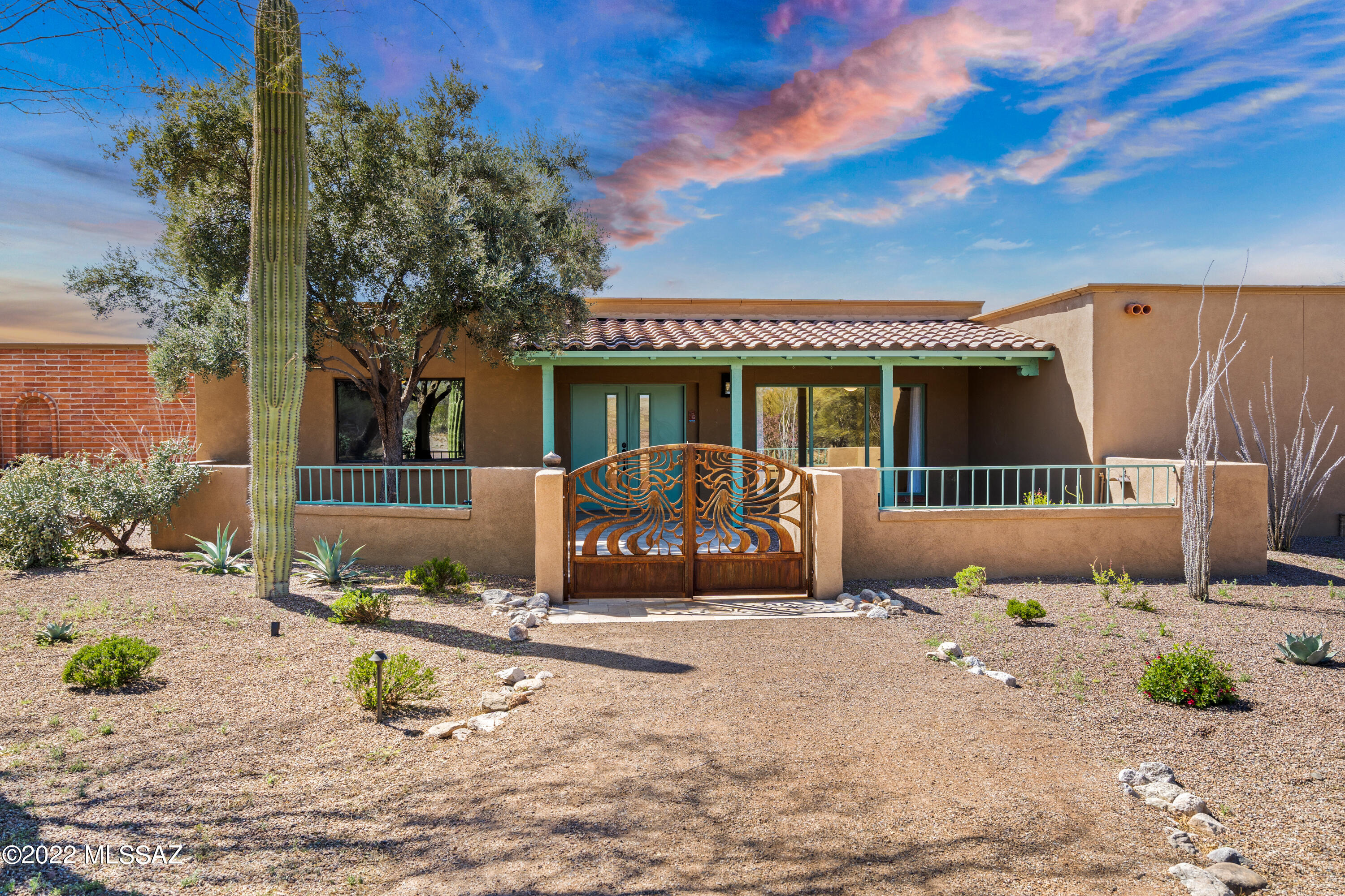 Don't miss this beautifully updated ranch home on 3.43 acres! Custom rusted gate invites you into a courtyard and front porch with double door entry into the home.  Gourmet kitchen is a dream with abundance of cabinets, double oven, oversized gas range and two drawer dishwasher. Built in buffet serving area and a separate butler's pantry are an added bonus. Stunning travertine flooring throughout main living areas. Primary bedroom has a  fireplace, attached sitting area and a spa-like bath with dual shower heads and a spacious oversize closet. Your outdoor living space is fully landscaped with a full length covered patio, roll down solar screens, TV jack and custom pool. A water harvesting tank takes care of the fruit trees and various plants. Mountain views and a sense of tranquility will have you sold on this home!!