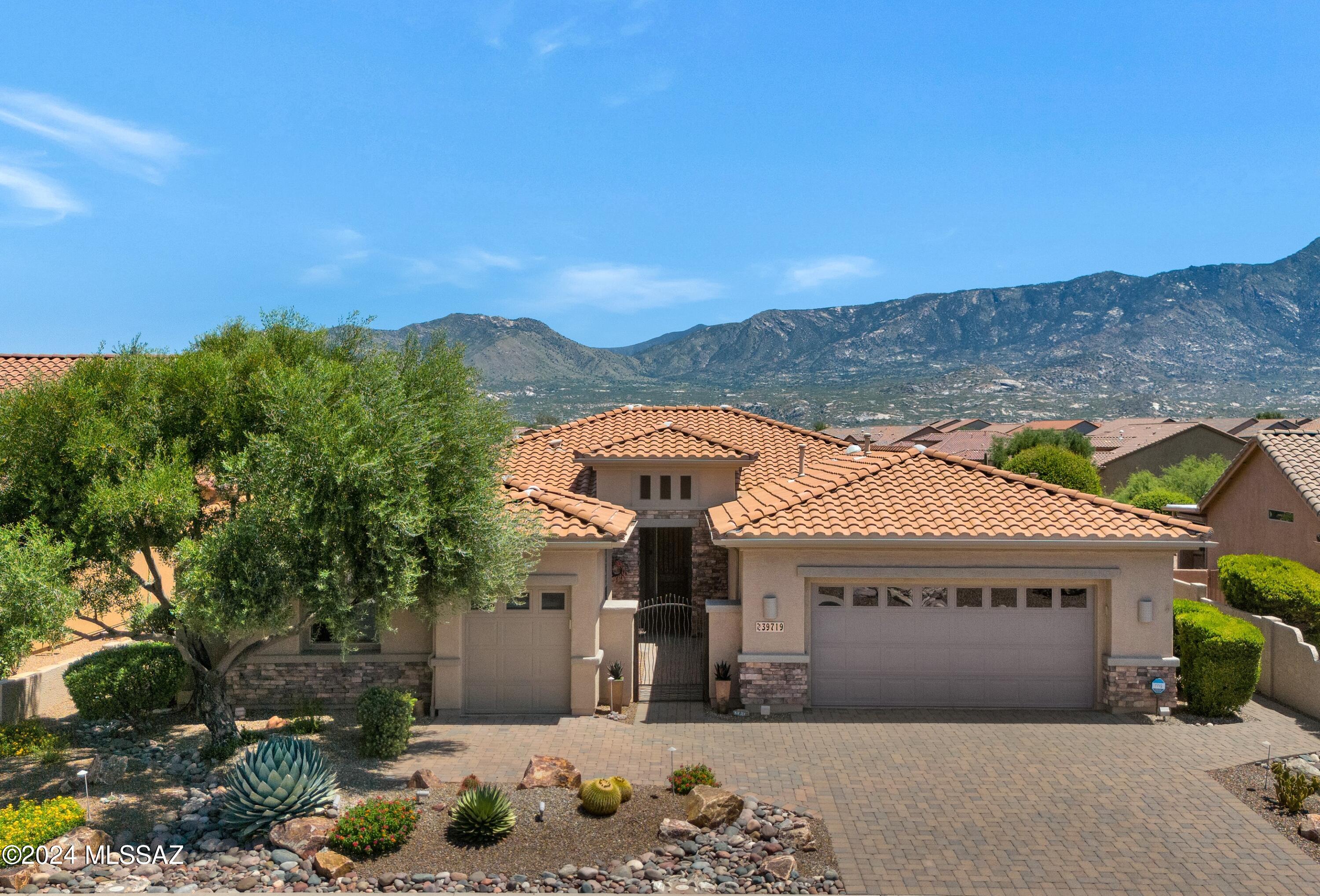 Upgraded Cimarron with Guest House, Owned Solar & Pool! Paver Driveway & Courtyard. Open Concept Living! Great Room with Gas Fireplace, Built-in Entertainment Wall & Slider to Patio. Kitchen has Granite Counters, Stainless Steel Appliances, Gas Range, Island, & Cabinets with pull-outs. Den has French Doors. Owner's Suite has Mountain Views. Owner's Bathroom with Walk-in Shower & Organized Walk-in Closet. Guest Bedroom with Closet & Bathroom nearby. Guest House has Closet & Bathroom. Laundry Room with W/D & Storage. Wood Interior Doors, Hunter Douglas Blinds, Tile & Vinyl Plank Floors. 2 Car Garage has Sink, Storage & separate Golf Cart Garage. Great Entertaining Yard with Covered Patio, Built-in BBQ, Firepit, Salt Water Pool, Owned Solar, Lovely Landscaping, Gated Yard & Mountain Views!