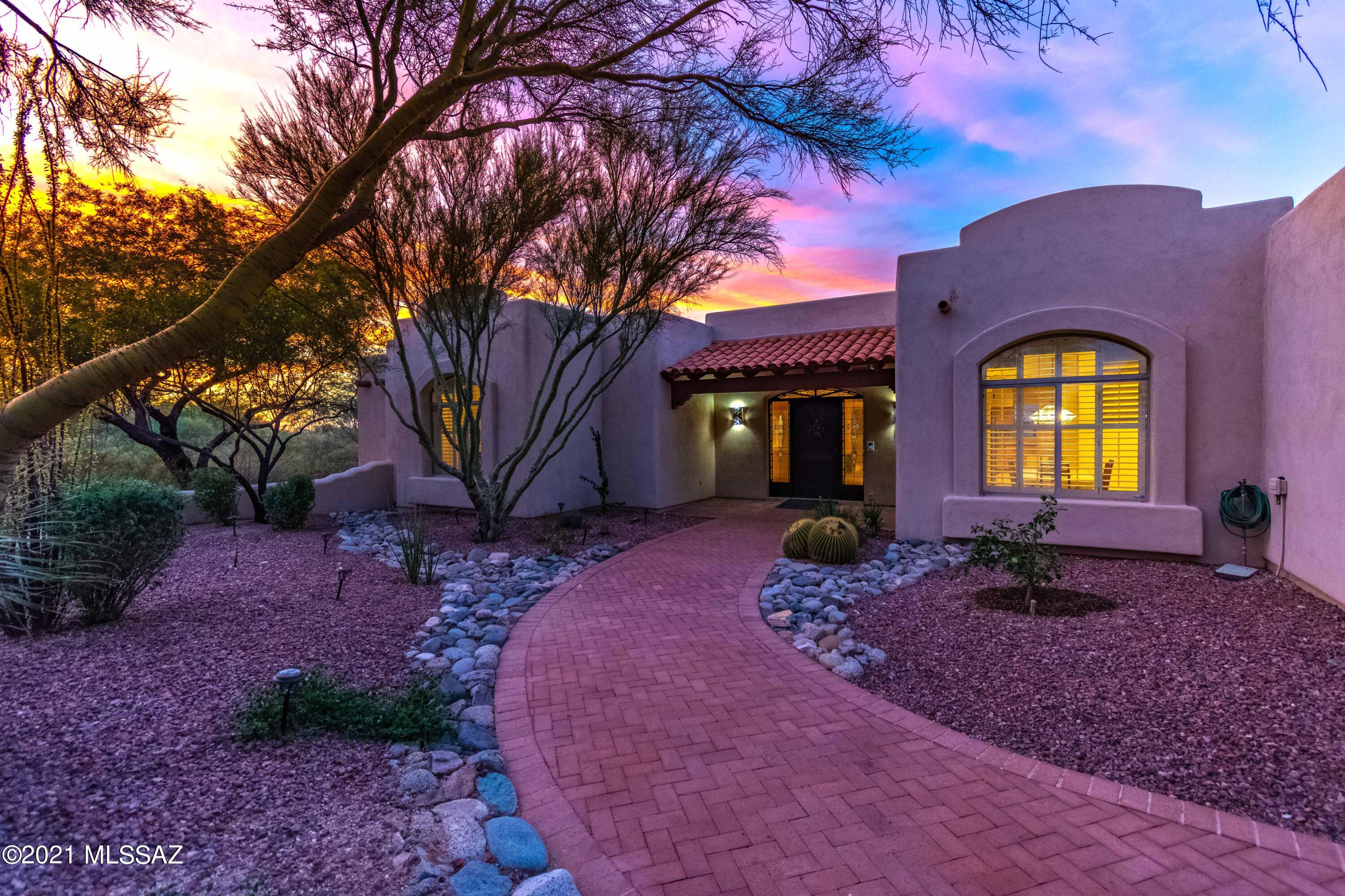 Exceptional privacy in the gated Wild Horse Ranch Estates community. This handicapped accessible home features 4 generous sized bedrooms and 3 full baths in over 3300 square feet of living space. The large foyer opens to the formal living room with gorgeous mountain views. Formal dining room looks onto the nicely landscaped front courtyard. The kitchen has plenty of space, including an island with breakfast bar and dining nook too. The kitchen opens to a large family room with fireplace that overlooks the north yard with extended covered patio,  PebbleTec pool and citrus grove. The 3 car garage provides plenty of parking and storage and includes a central vacuum system. Solar panels are owned (no lease). Please see attached features list for more.