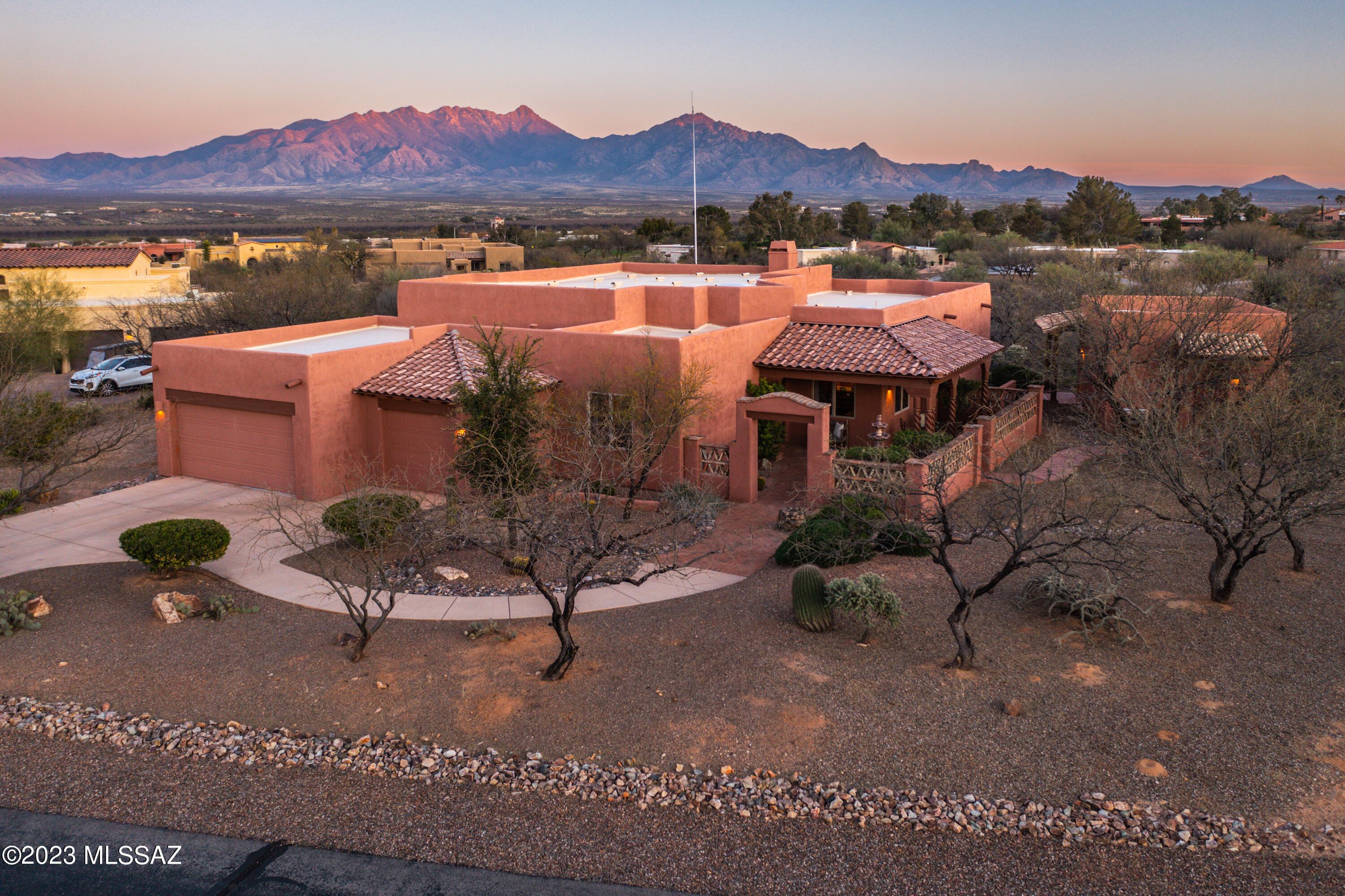 This stunning Santa Fe-Style Custom Built house boasts a 2,556 square foot main house and a 460 square foot casita built by Gary Cooper that are both beautifully designed. It welcomes you into a private courtyard and peaceful tiered fountain. This property has breathtaking mountain views from the great room, which also features a cozy kiva fireplace plus Mexican Saltillo tile through-out. The wrap-around patio is perfect for enjoying the gorgeous views and outdoor living. The beautiful, coffered ceilings, wood beams and rope pillars in the dining room gives it that nostalgic feeling of an old hacienda. This theme transitions into the large gourmet kitchen that features beautiful alder cabinetry, Electrolux 6 burner stove top, built-in Frigidaire microwave and granite countertops. This home has been upgraded with many luxury features that makes it stand out. New roof in April 2023. Don't miss this opportunity to own this unique property that offers both luxury and a peaceful retreat in one package! All furnishings available through separate bill of sale.
