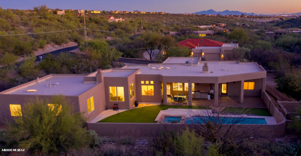 Resort living in this Catalina Foothills contemporary . Gorgeous Mountain views  in this tranquil  1 acre setting. Light filled gracious spaces in this split floor plan. Hansome Travertine tile floor.  Gourmet Island kitchen finished in granite and maple. Family room area w/expansive area for tv, fireplace, and great views.  Master suite w/gas fireplace, large master bath w/ jetted tub,  dual head shower, 7 two  walk in closets. North/South orientation provides tremendous views from inside and out. Stellar yard features extensive covered patio, large pool with ''fast current'' swim device for complete work out and turf for easy care lawn. Close to Sabino Canyon, shopping, restaurants, golf and more. CONTACT MADELINE FOR PERSONAL LIVE DIGITAL TOUR.