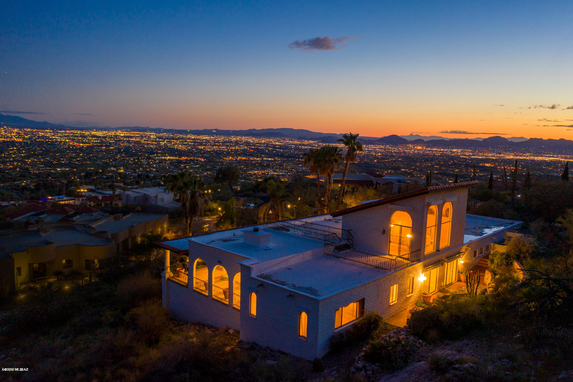 Live on top of the world. Built on one of the highest home sites in all of Tucson overlooking the beautiful valley floor. Experience some of the best views in the city w/ 3 mountain ranges in plain view & a fourth, the most impressive being in your backyard. The timeless Spanish, Mediterranean feel was designed by the notable Tucson architect, David Fraker.  Solidly built & sited on almost 5 acres behind the guard gated entrance of the prestigious Skyline Country Club, you will be sure to enjoy the floor to ceiling picturesque views from every room of this 3884sqft estate. Unique details include a classical clerestory entry, beamed ceilings, his & hers master bathrooms & a large stone fireplace. See for yourself the endless possibilities & limitless potential this home has to offer